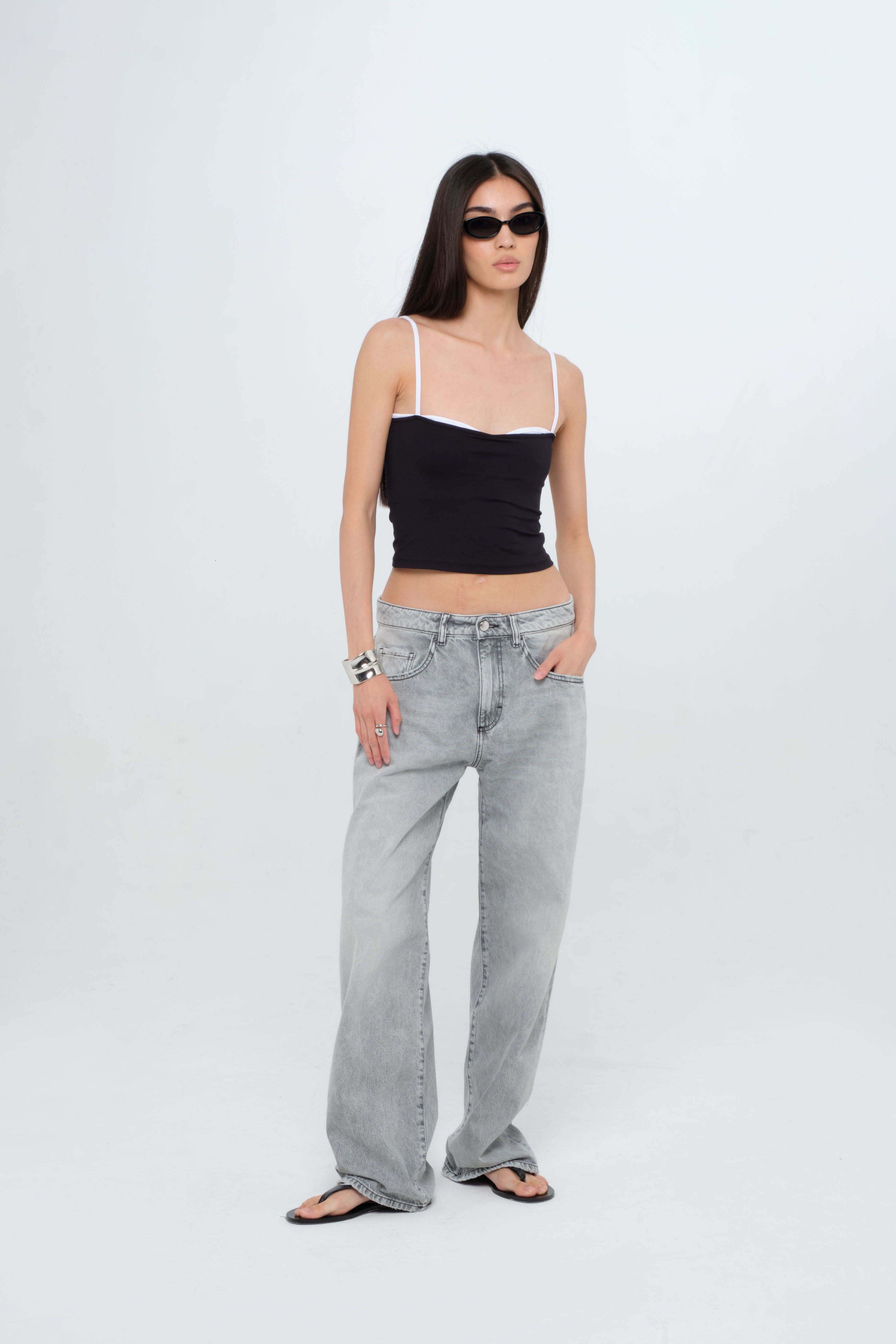 Bea women’s wide leg jeans in gray wash, 100% rigid cotton denim, worn by a model with a black top.