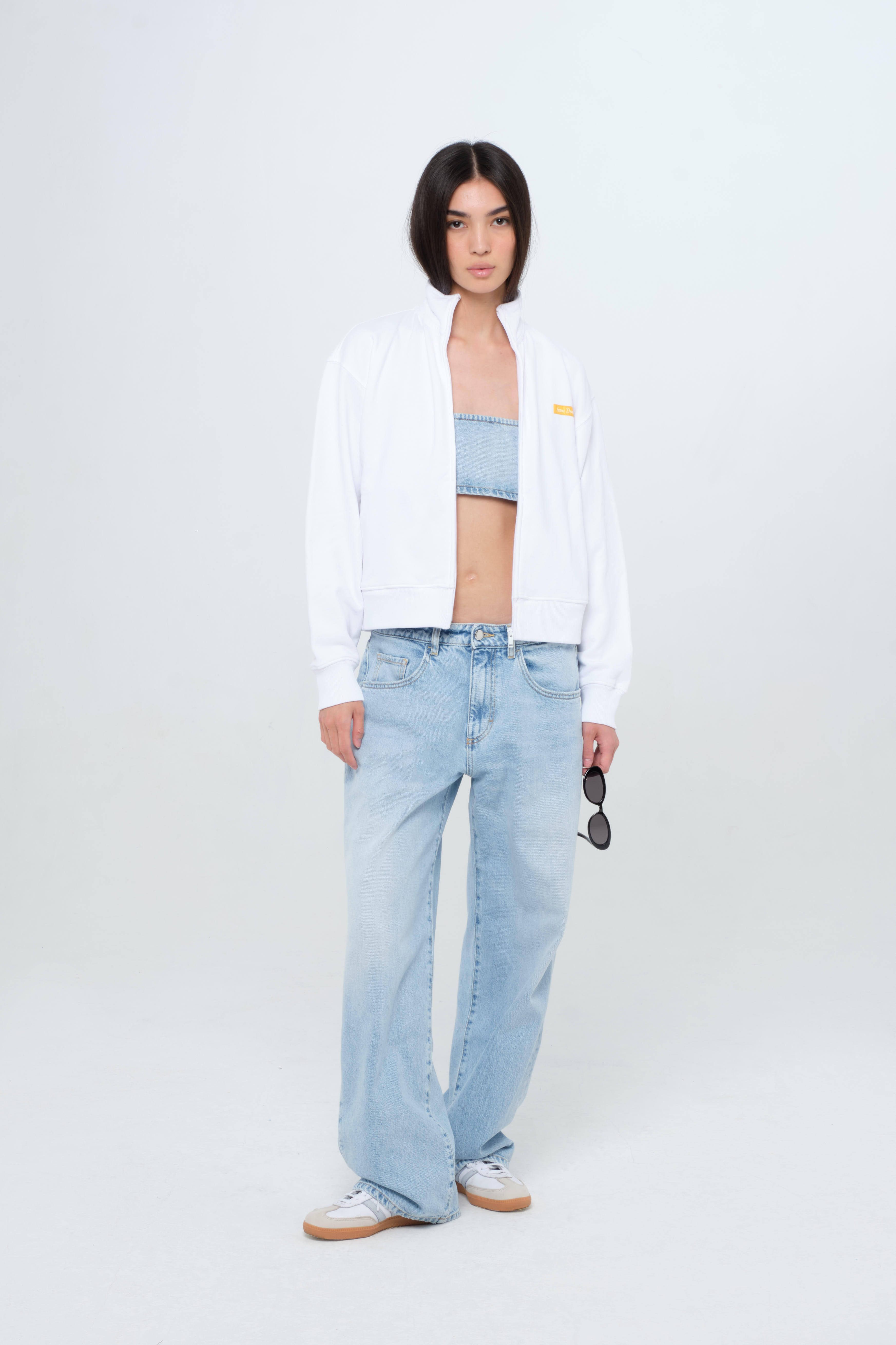 Bea women’s wide leg jeans in light wash, 100% rigid cotton denim, worn by a model with denim top and white jersey.