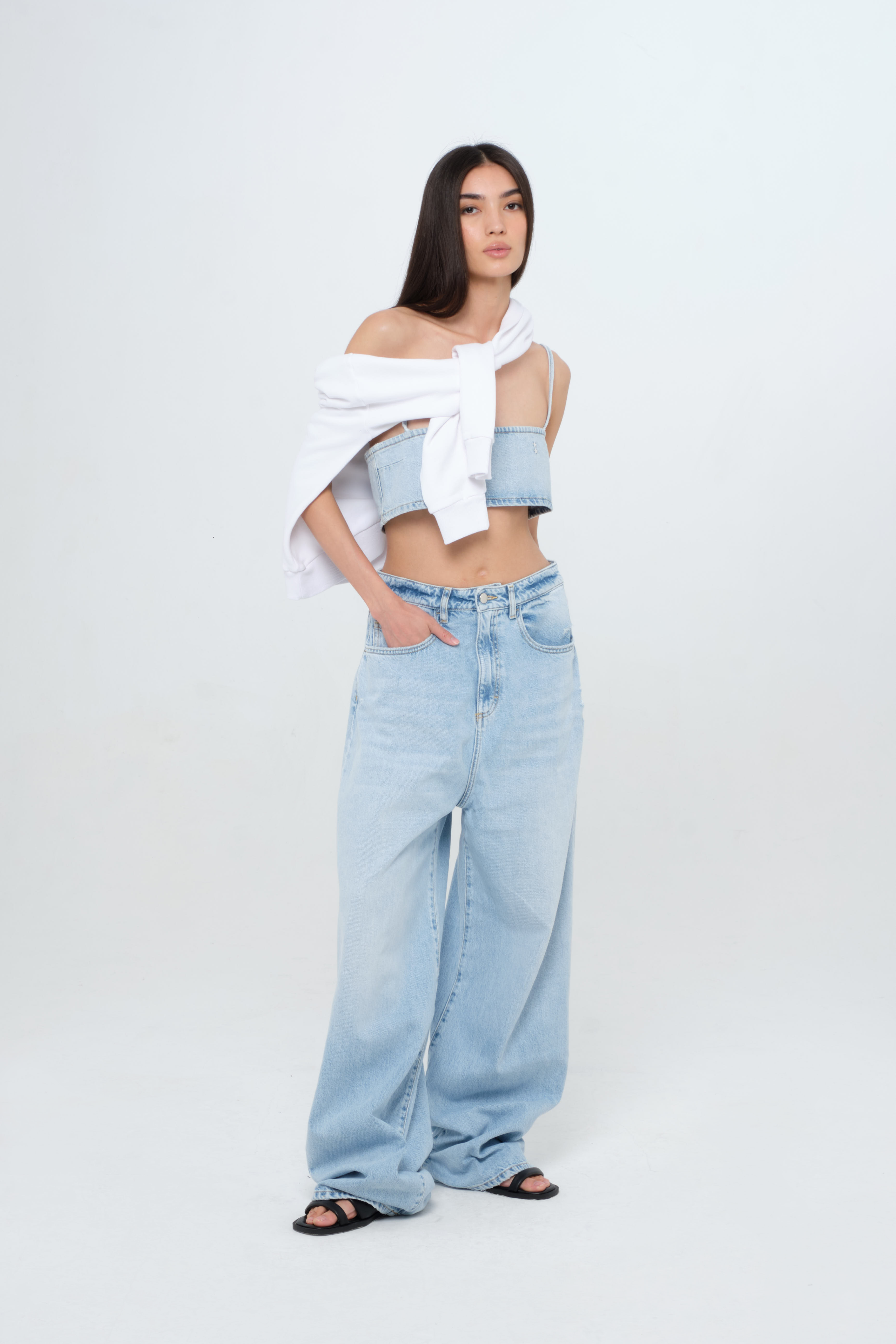 Coco women’s wide leg jeans in light wash, 100% rigid cotton denim, worn by a model with denim top and white sweatshirt.