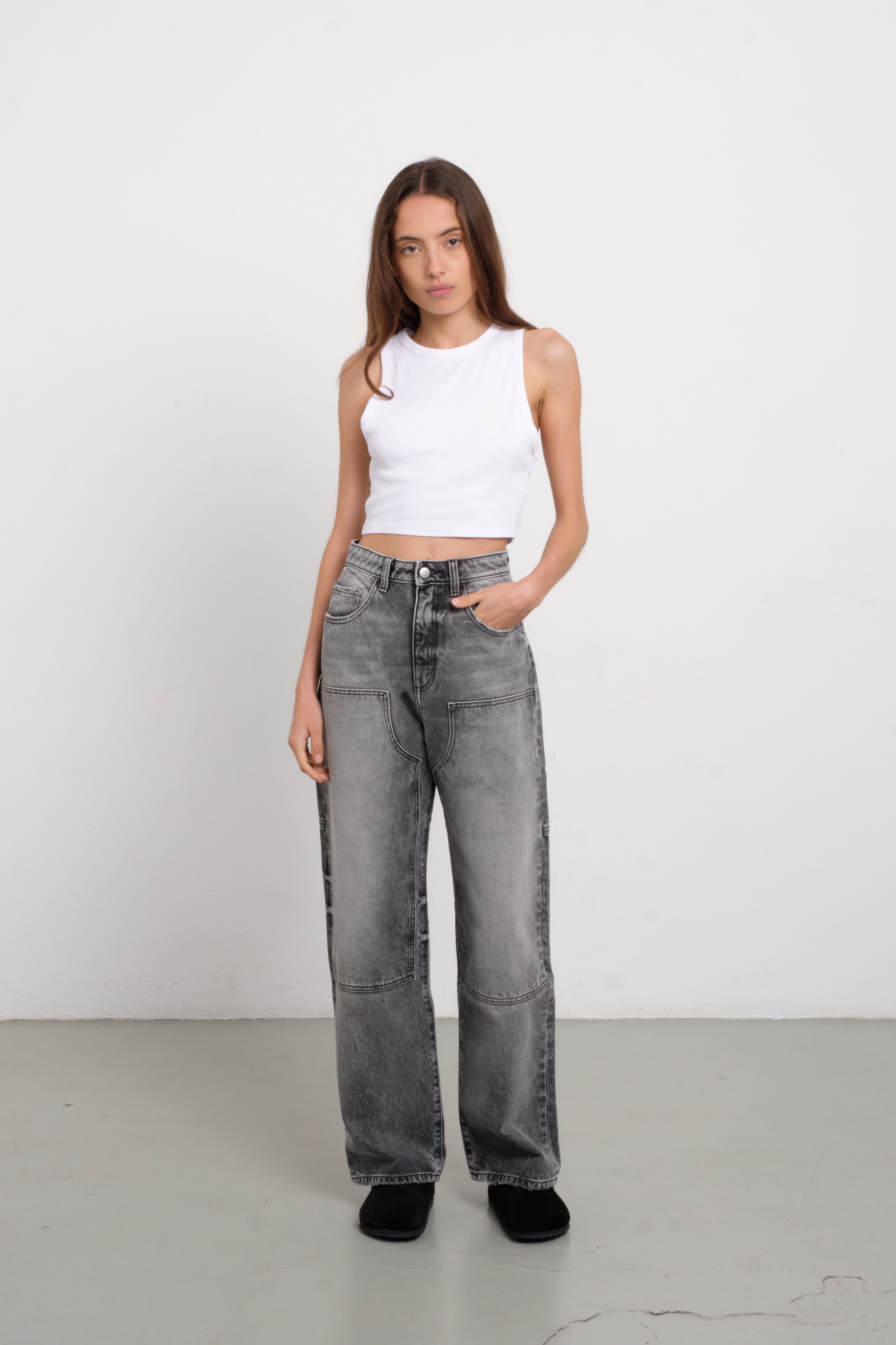 Jenny women’s straight leg jeans in dark gray wash, 100% rigid cotton denim, worn by a model with a blue tank top.