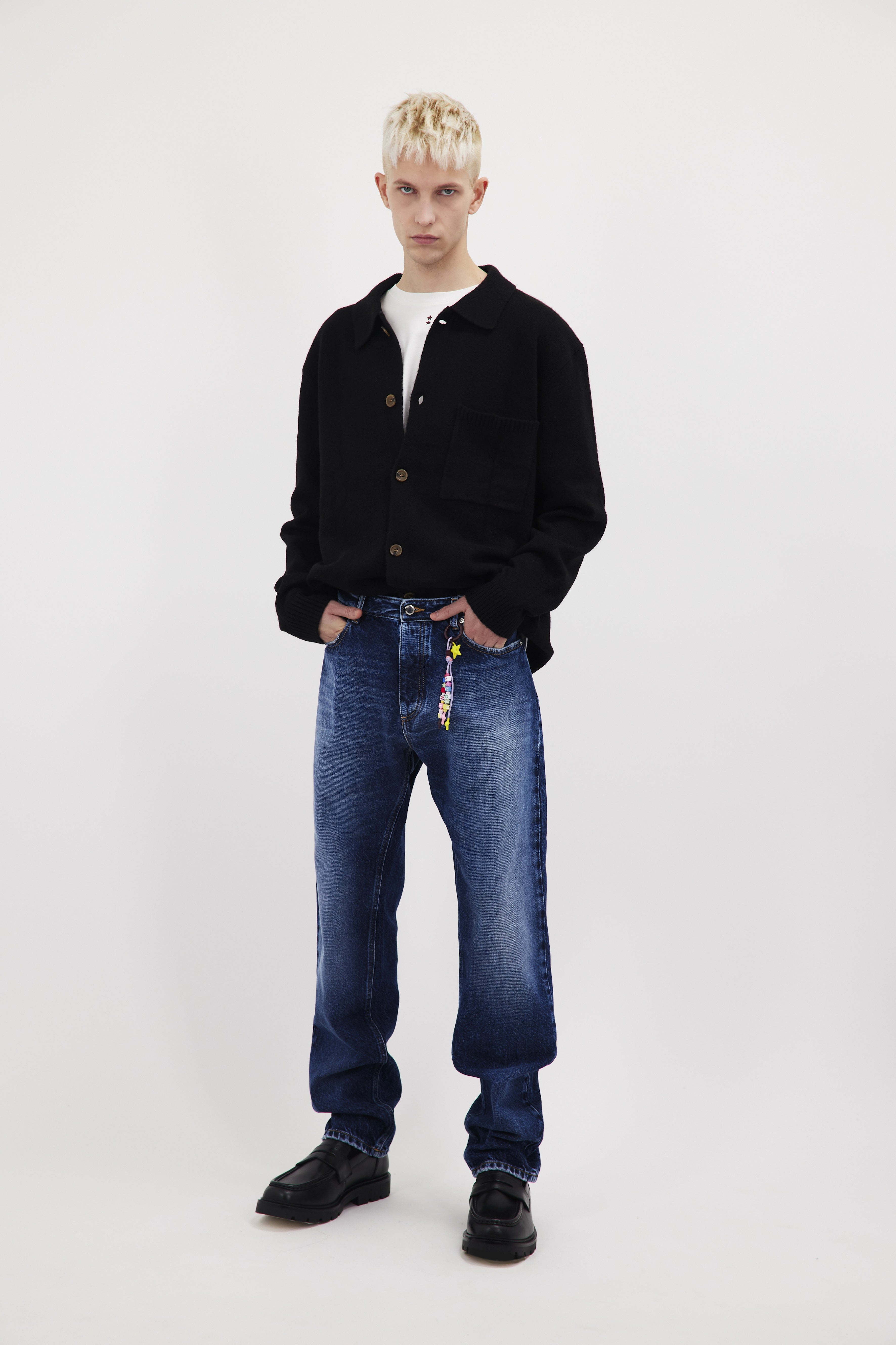 Kanye men’s loose jeans in eclipse wash, 100% rigid cotton denim, worn by a model with a black long sleeve.