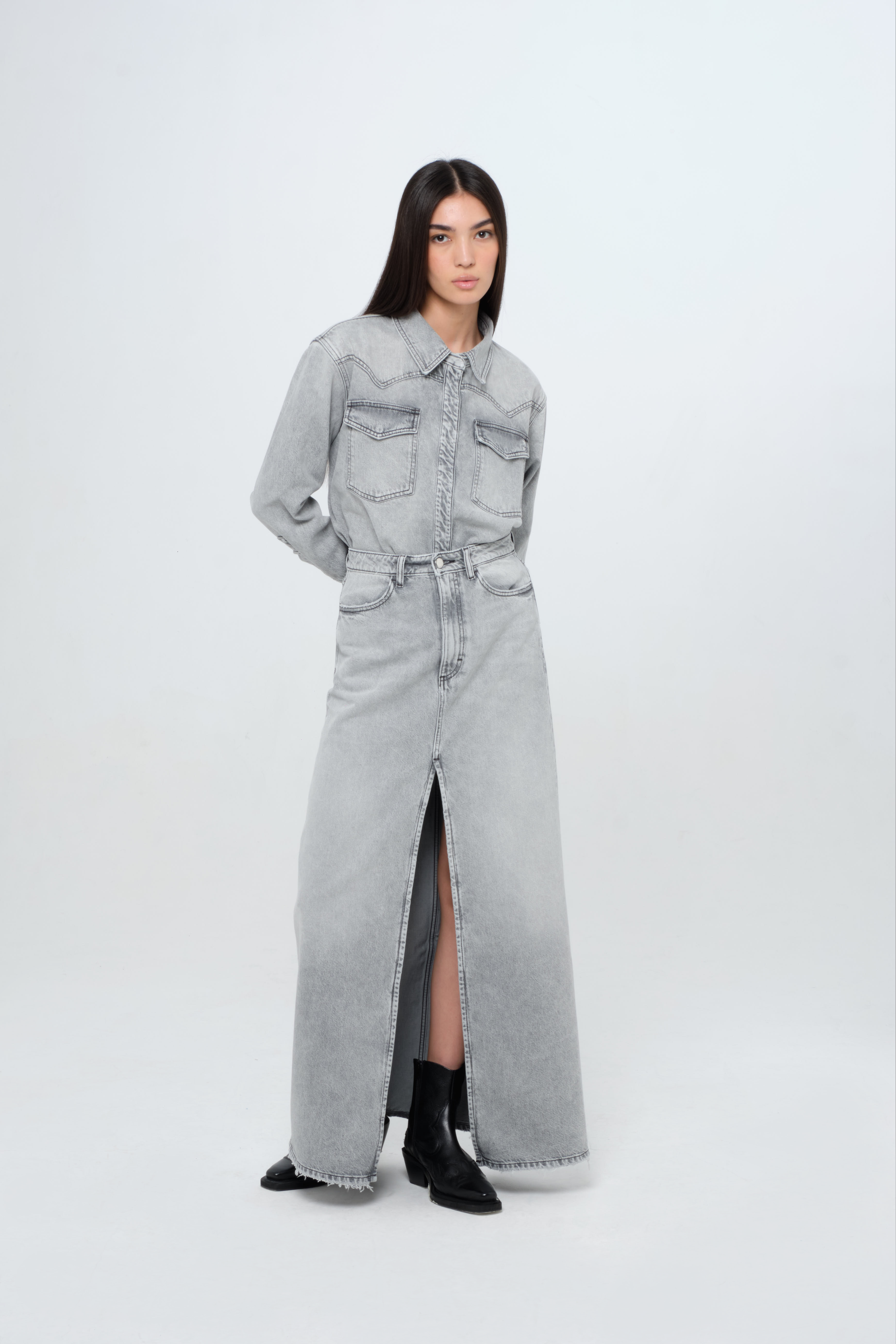 Lara women’s long skirt in gray wash, 100% rigid cotton denim, worn by a model with a gray wash denim shirt.