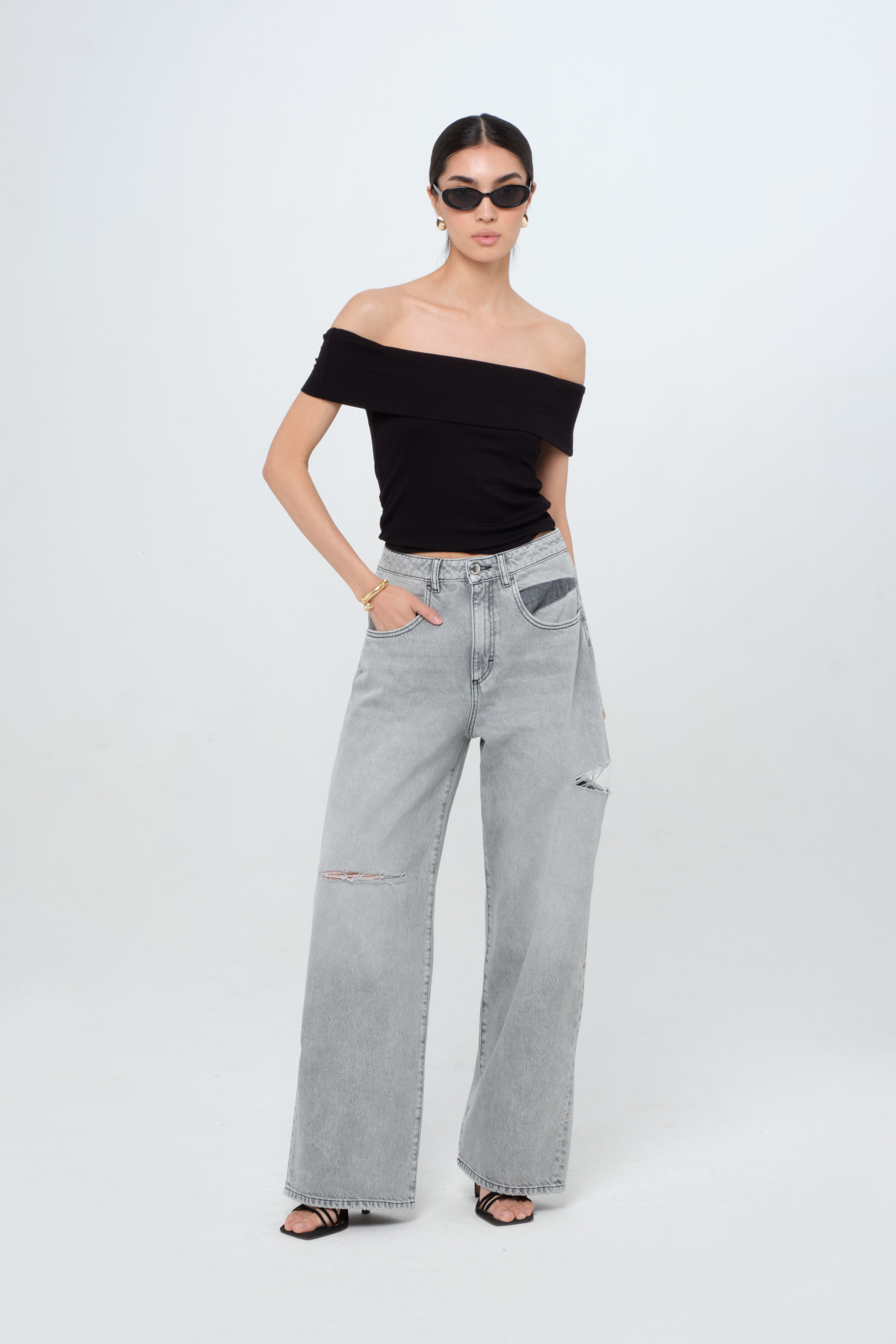 Poppy women’s wide leg jeans in gray wash, 100% rigid cotton denim, worn by a model with a black top.