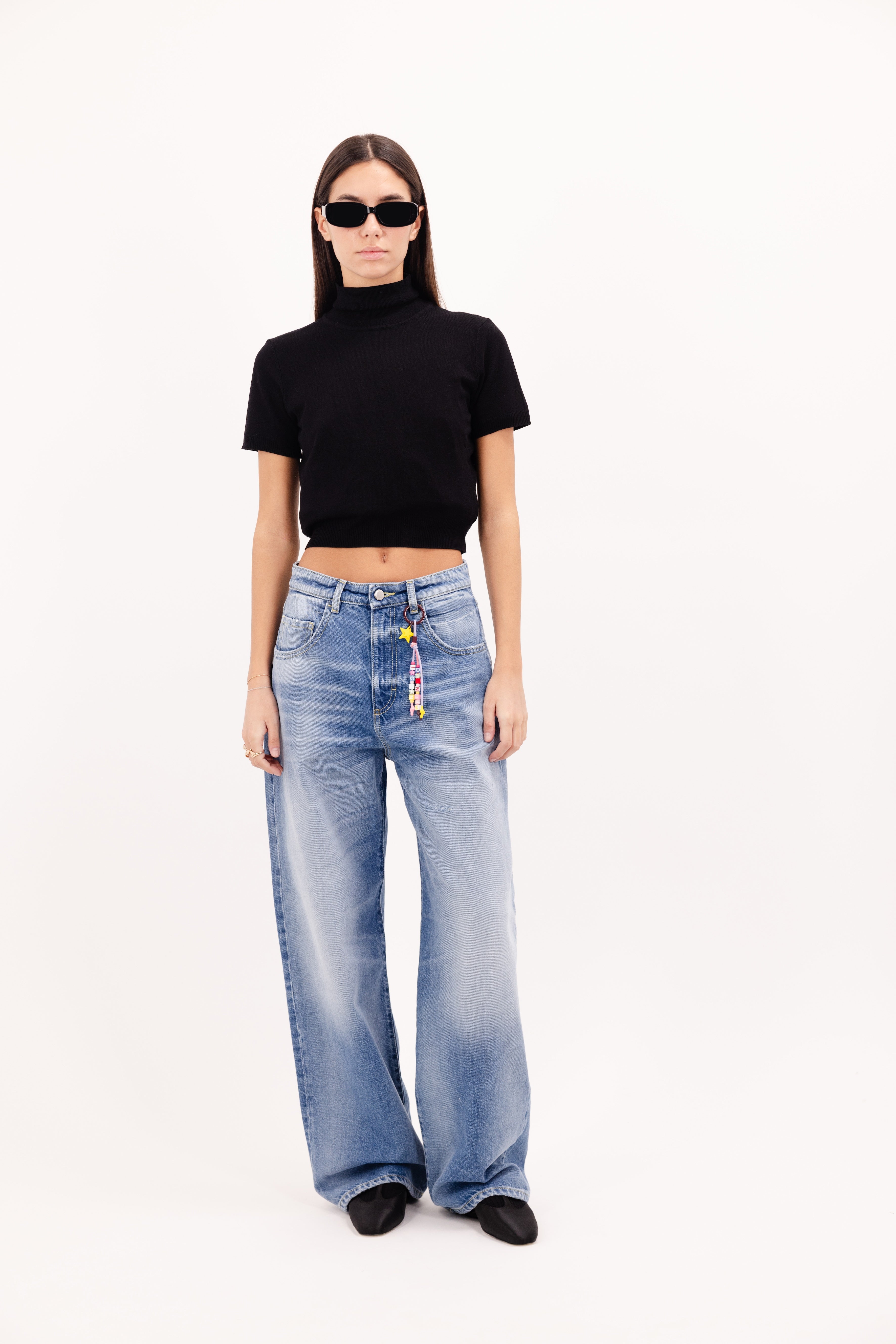 Poppy women’s wide leg jeans in misty blue wash, 100% rigid cotton denim, worn by a model with a black top.