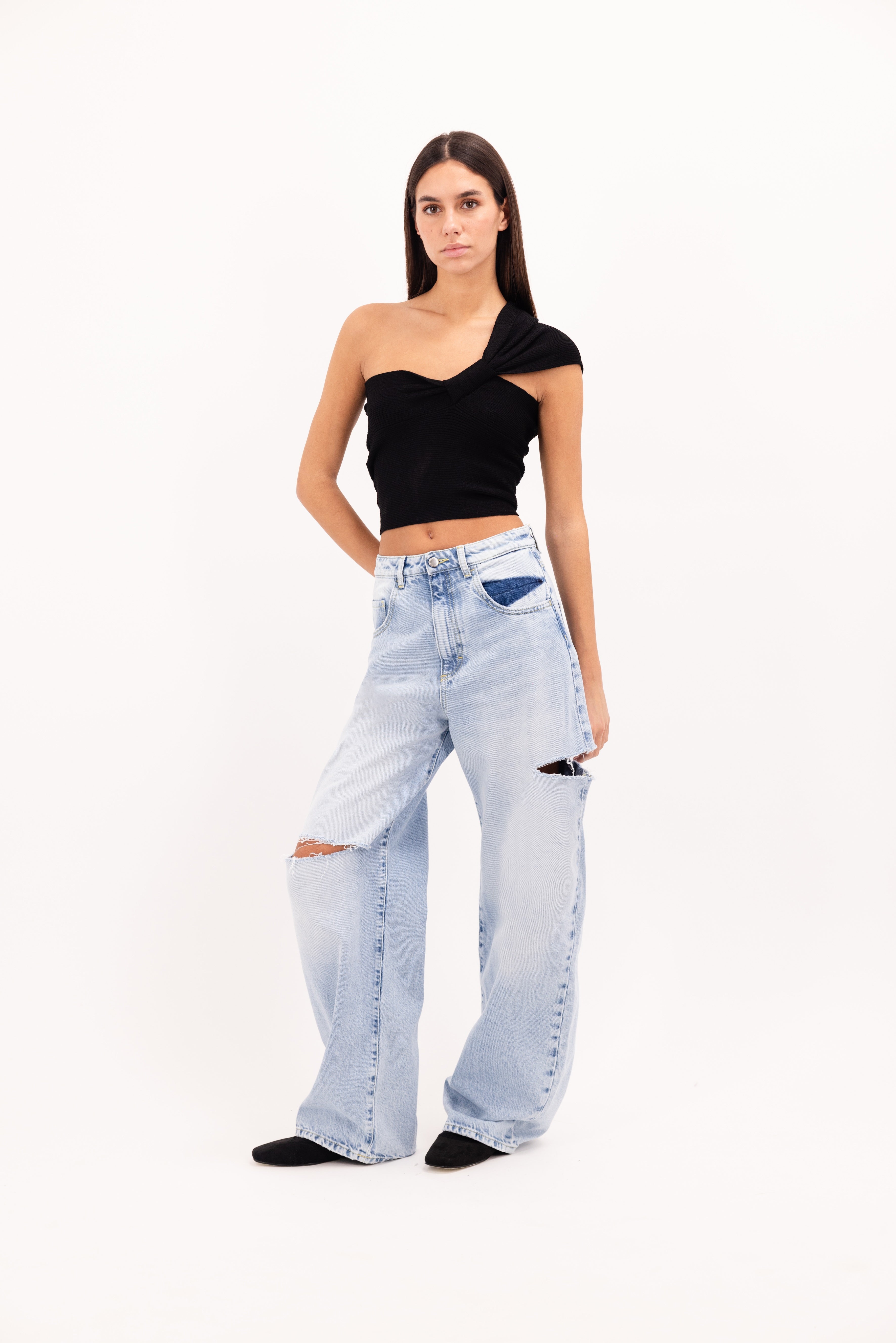 Poppy women’s wide leg jeans in sky blue wash, 100% rigid cotton denim, worn by a model with a black top.