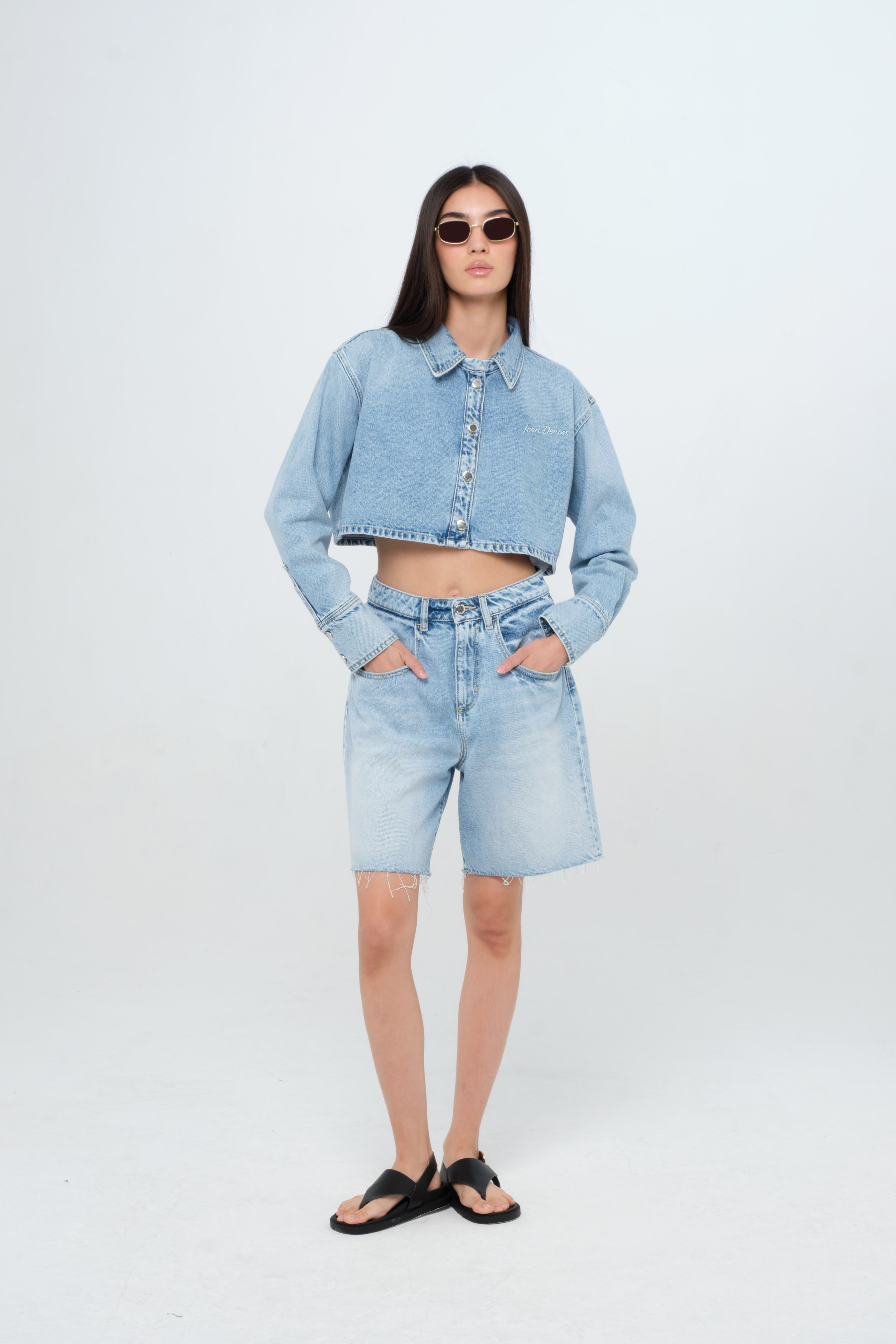 Amber women’s denim shirt in light wash, 100% rigid cotton denim, worn by a model with a denim short.