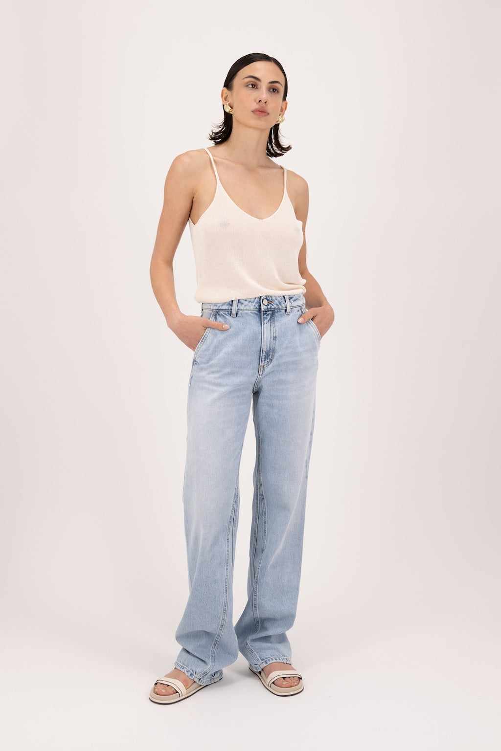 Annie women’s straight leg jeans in sky blue wash, 100% rigid cotton denim, worn by a model with a white tank top.