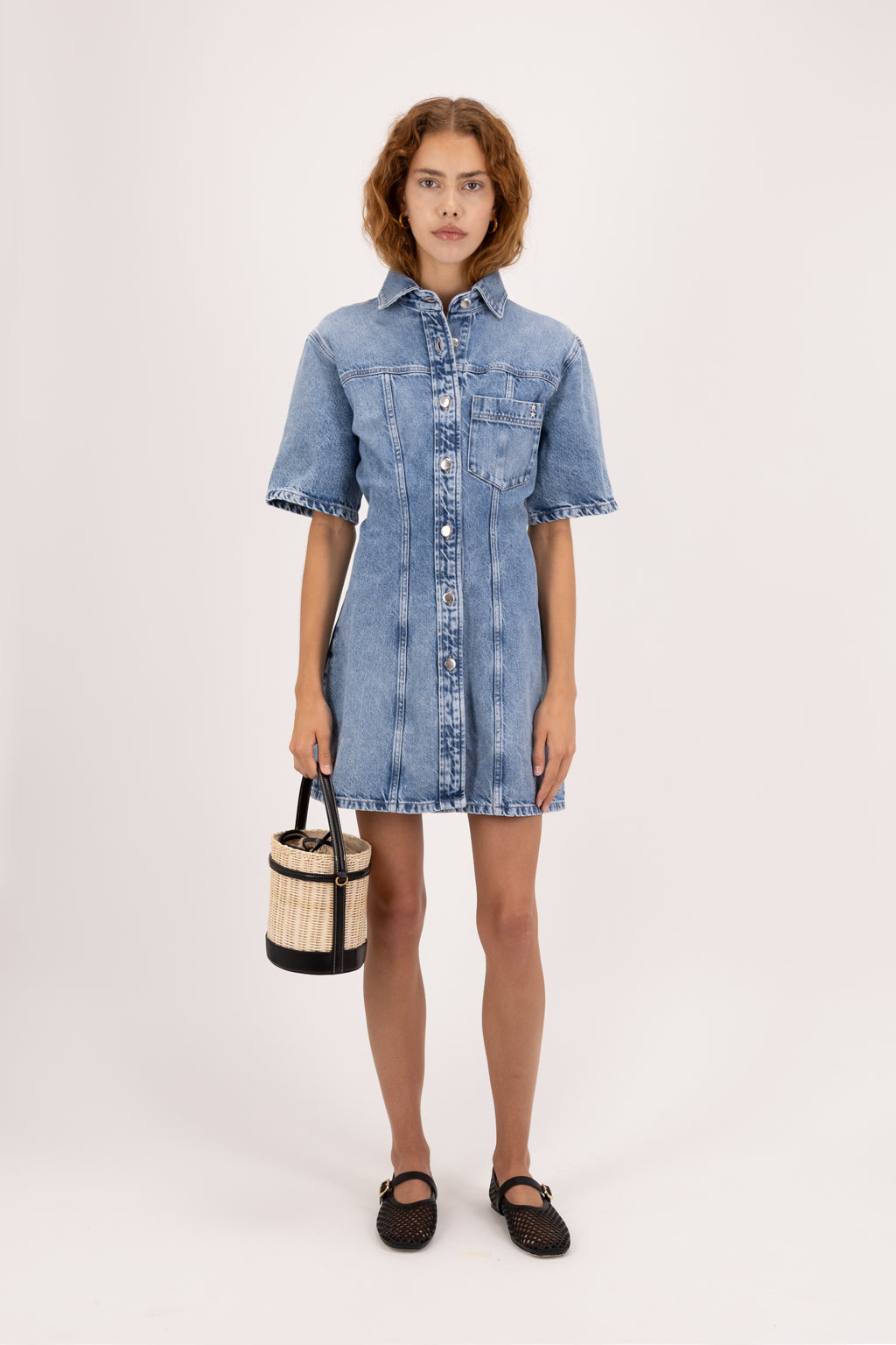 Bambi women’s dress in river wash, 100% rigid cotton denim, worn by a model.
