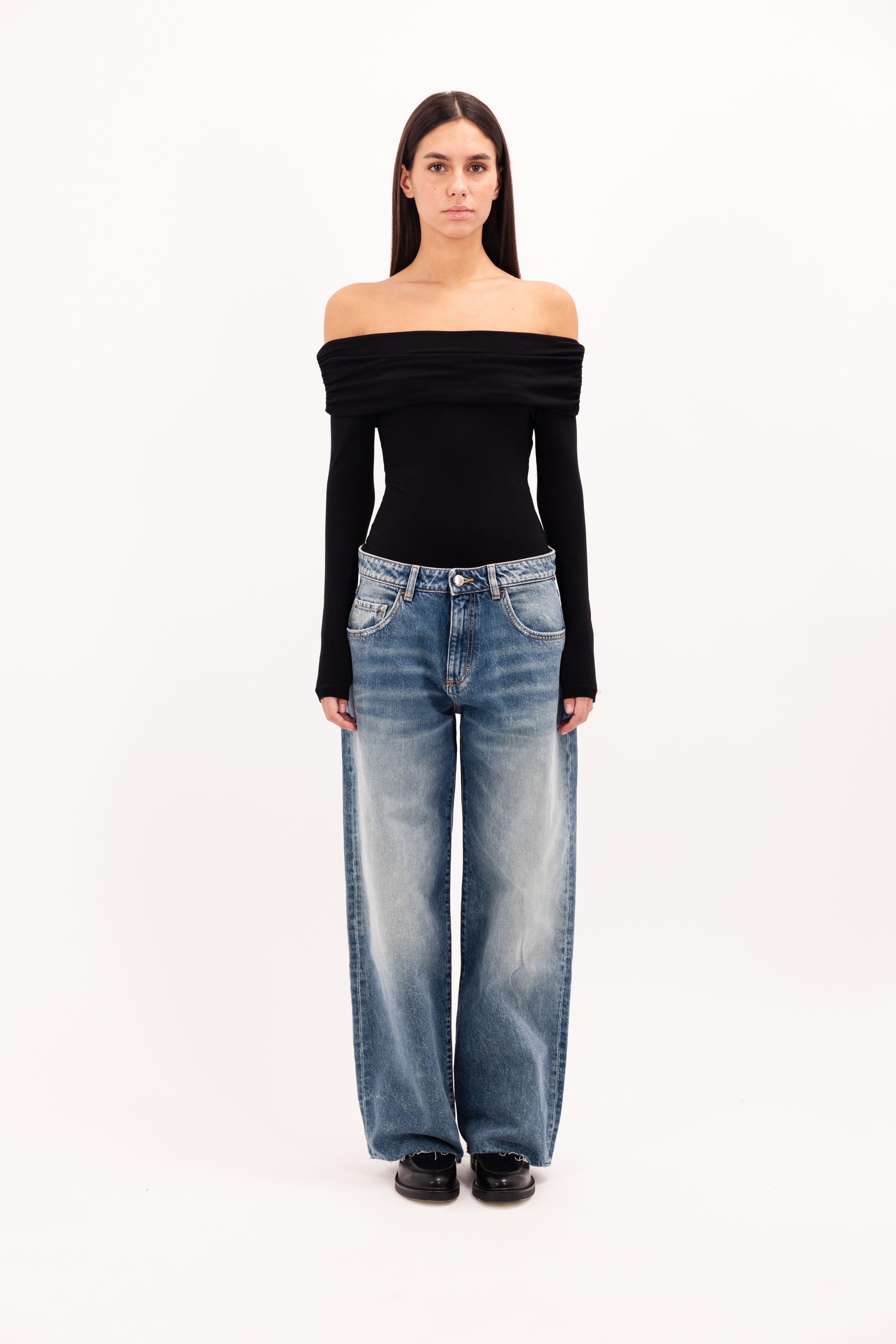 Bea women’s wide leg jeans in aged stone wash, 100% rigid cotton denim, worn by a model with a black top.