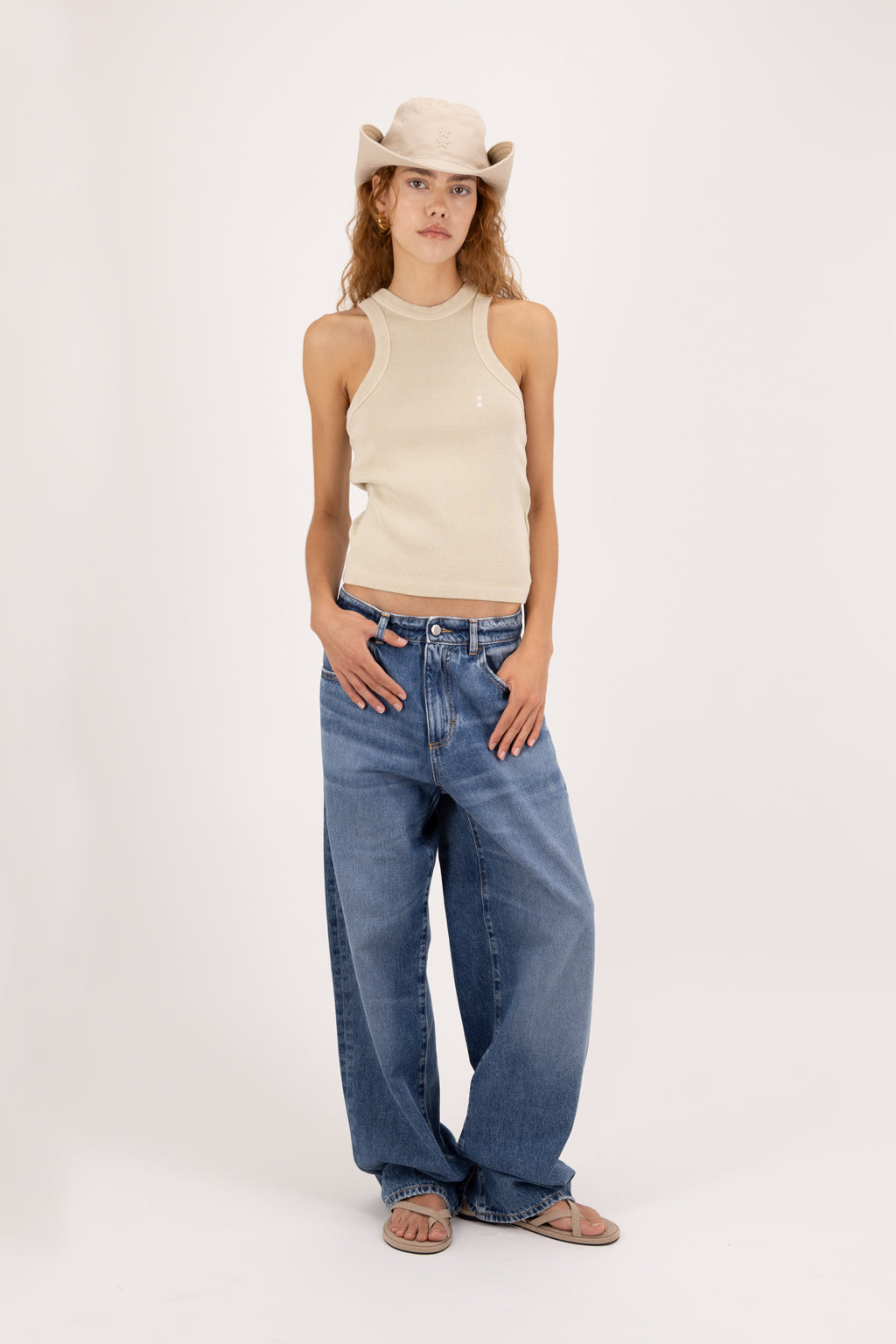 Bea women’s wide leg jeans in eclipse wash, 100% rigid cotton denim, worn by a model with a beige tank top.