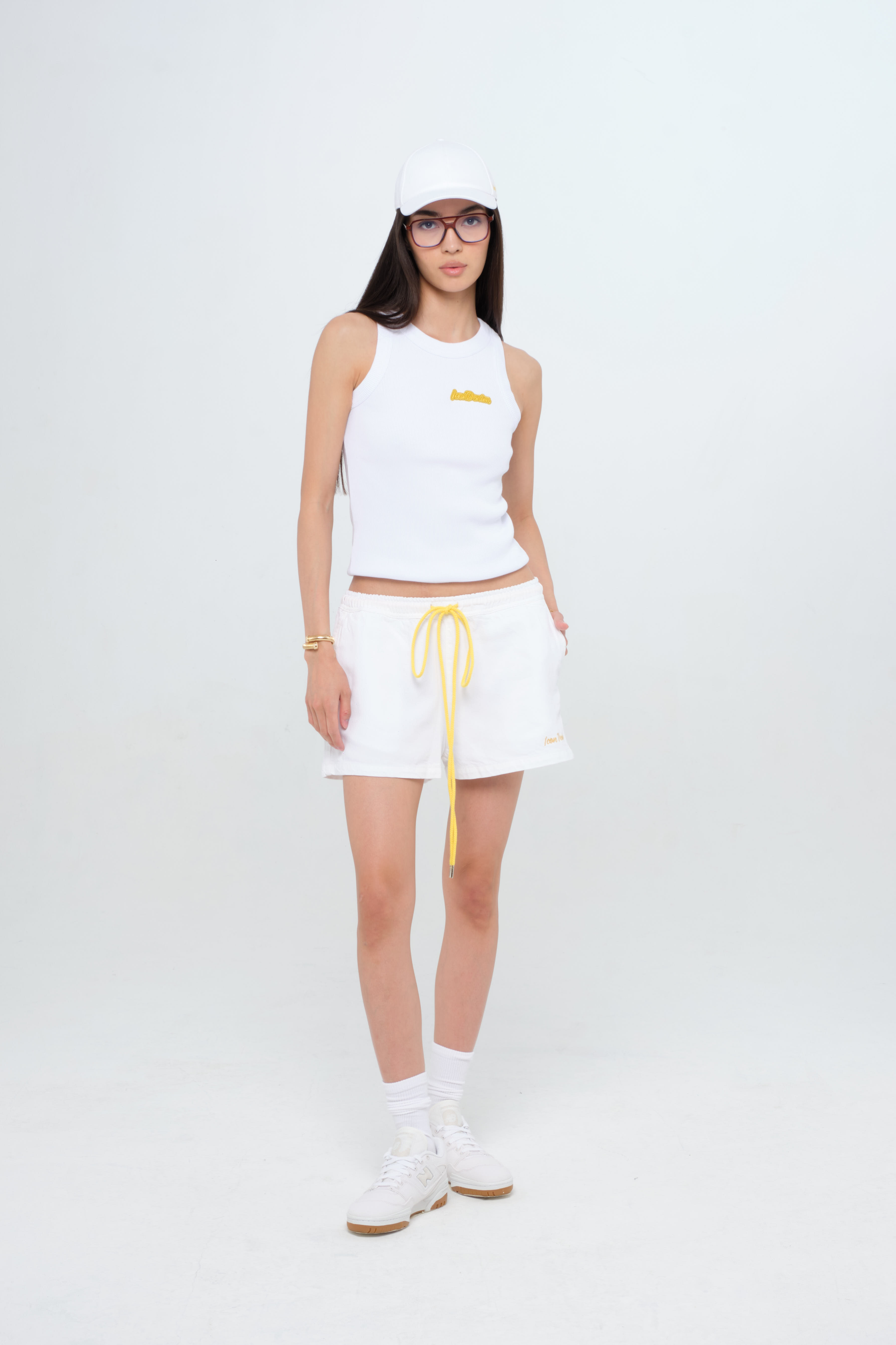 Carrie women’s wide leg short jeans in white, 100% rigid soft cotton denim, worn by a model with a white tank top.