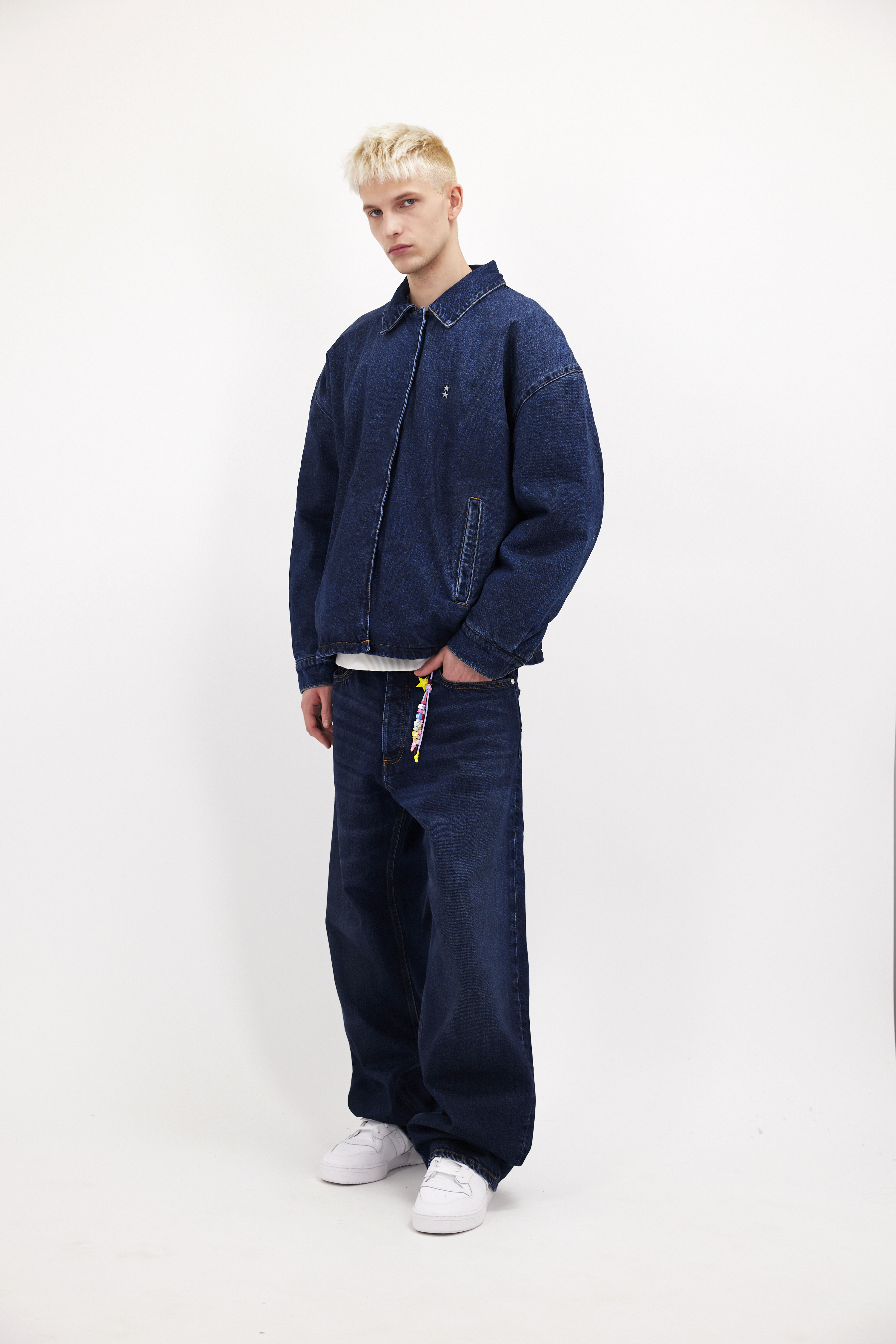 Chandler men’s jacket in dusty blue wash, 100% rigid cotton denim, worn by a model with jeans.