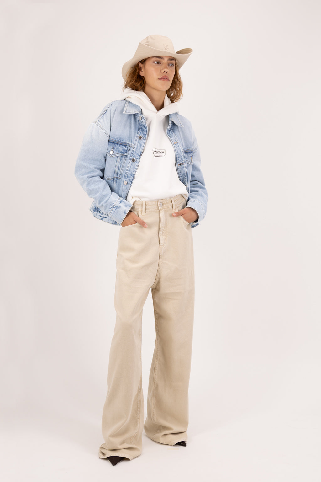 Coco women’s wide leg jeans in desert wash, 100% rigid soft cotton denim, worn by a model with a denim jacket.