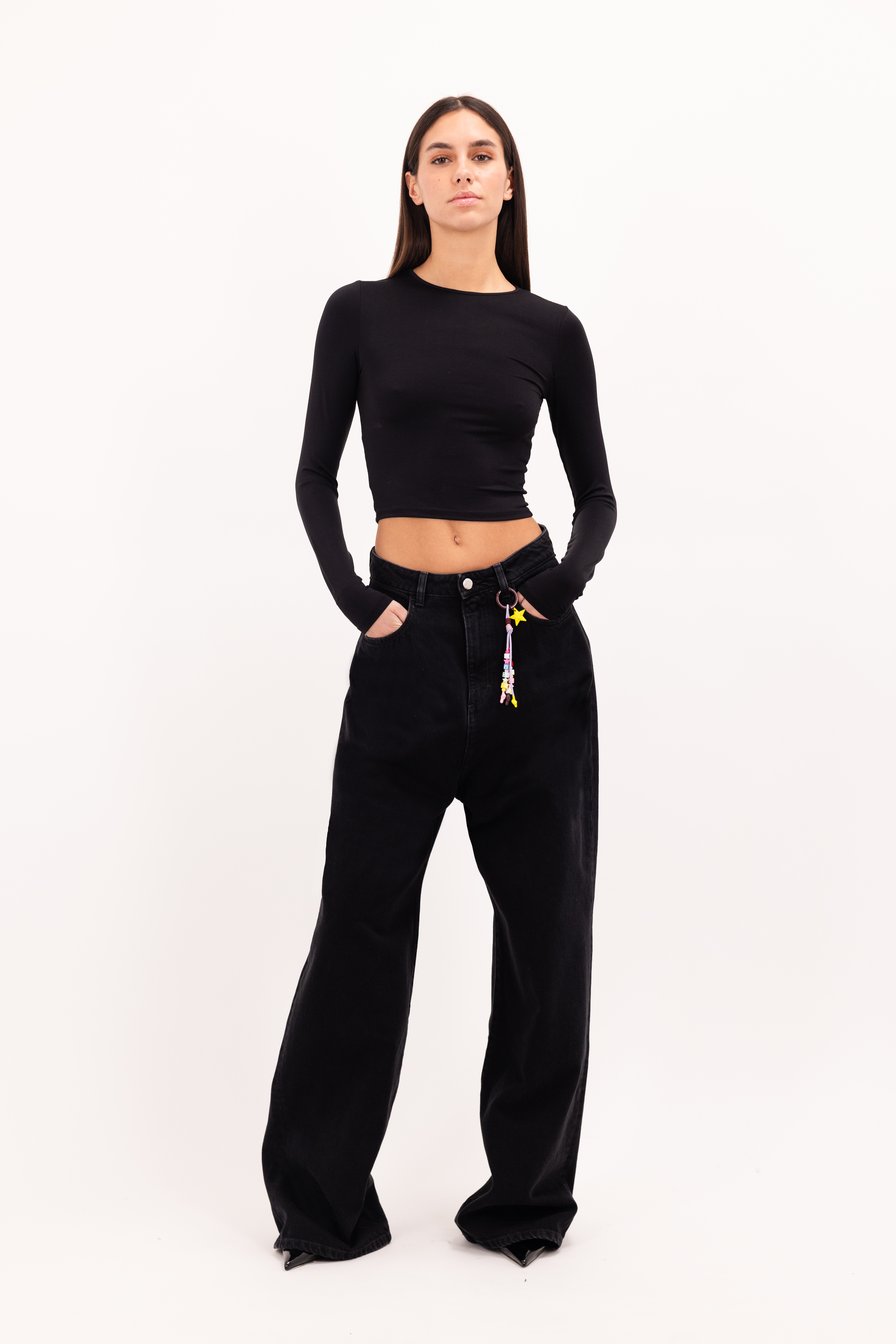 Coco women’s wide leg jeans in graphite black wash, 100% rigid cotton denim, worn by a model with a black top.