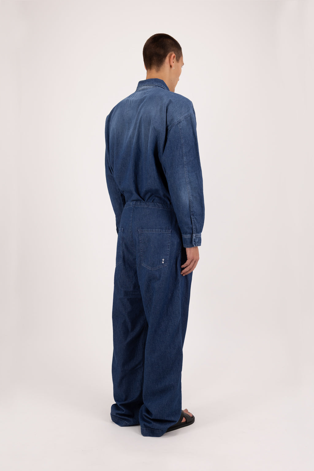 Back view of Cody men’s wide leg jeans in night wash, 100% ultra light cotton denim, worn by a model with a denim shirt.