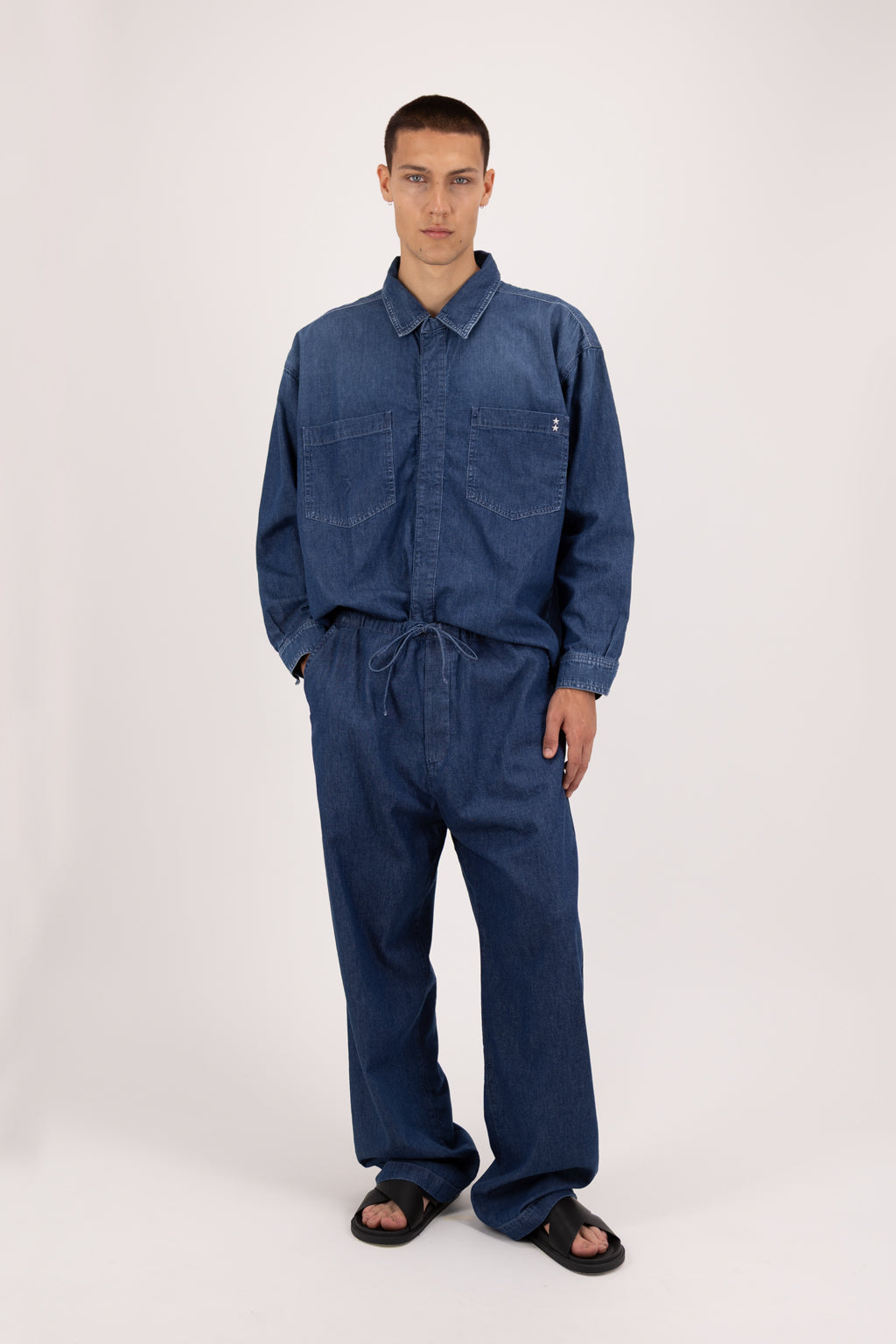 Cody men’s wide leg jeans in night wash, 100% ultra light cotton denim, worn by a model with a denim shirt.