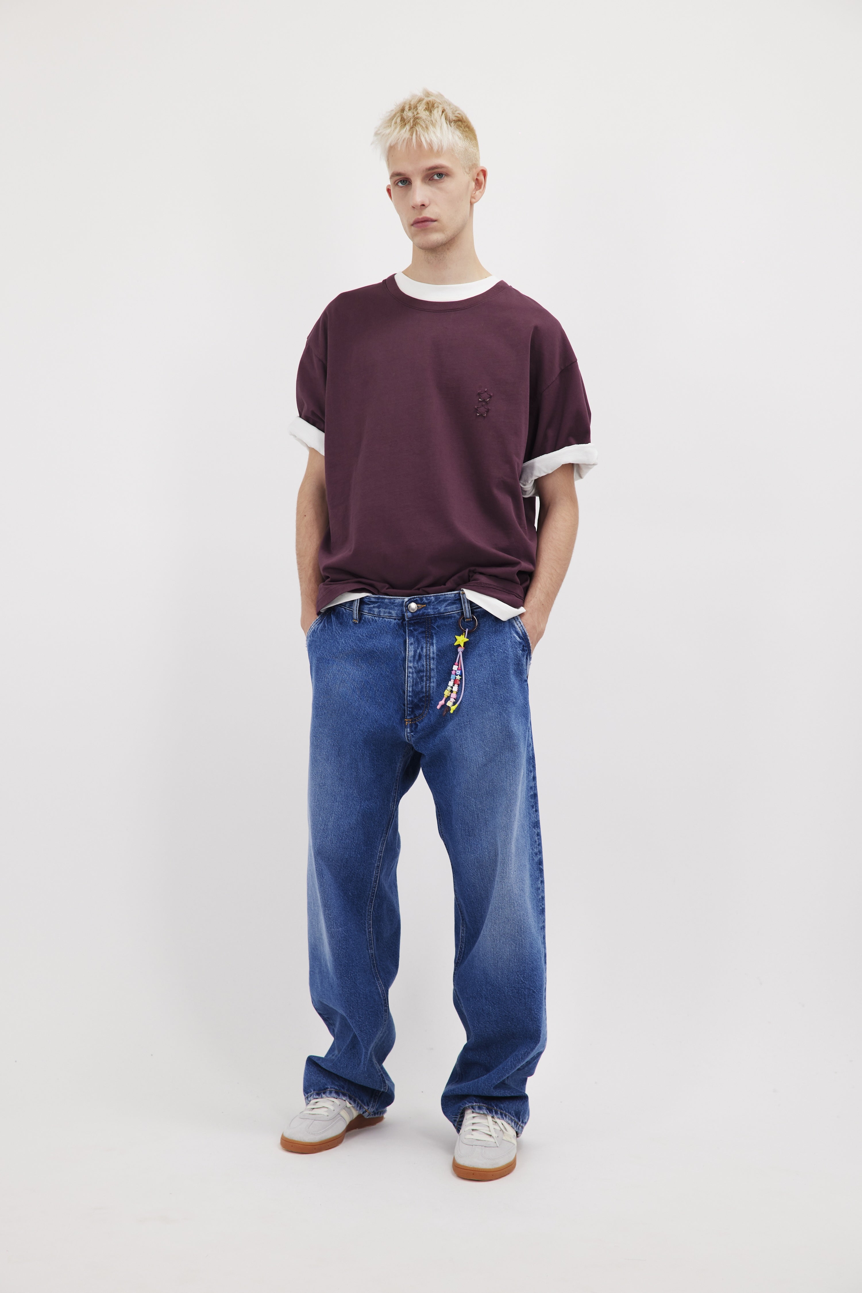 Dave men’s wide-cut leg jeans in eclipse wash, 100% rigid cotton denim, worn by a model with a cherry t-shirt.