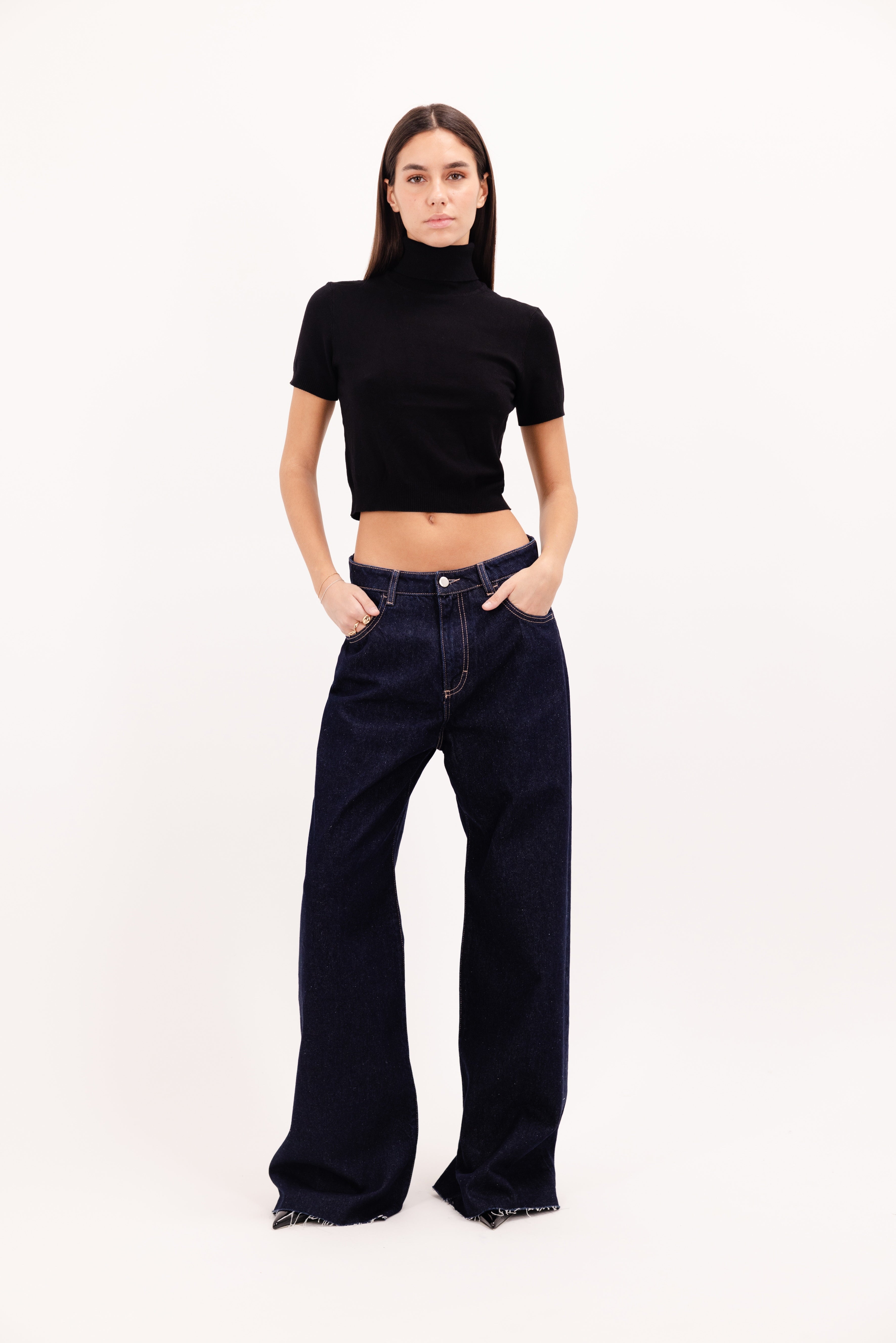 Debby women’s wide leg jeans in indigo raw wash, 100% rigid cotton denim, worn by a model with a black top.