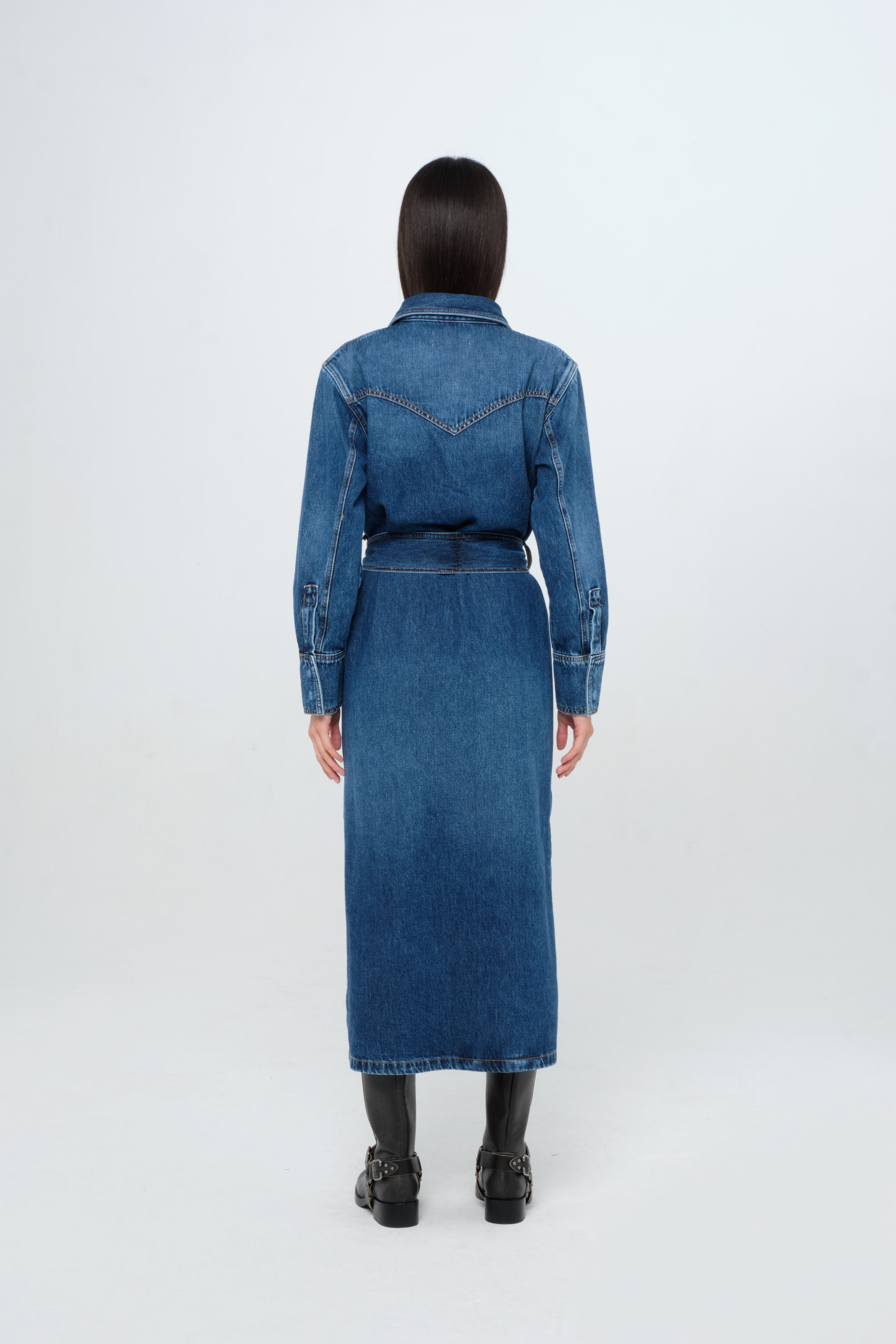 Back view of Ellen women’s dress in dark wash, 100% rigid cotton denim, worn by a model.