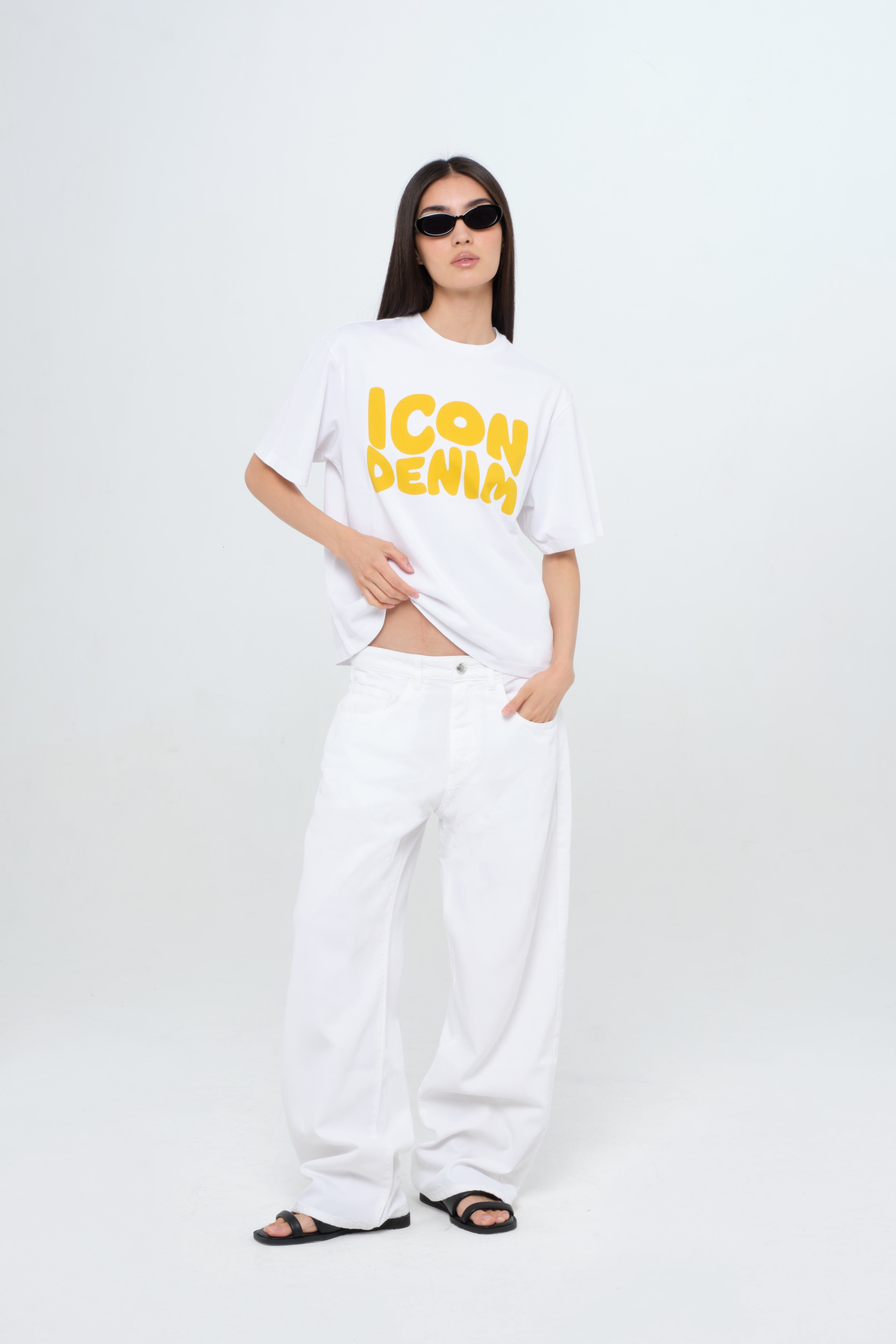 Debby women’s wide leg jeans in white, 100% soft rigid cotton denim, worn by a model with a white tank top.