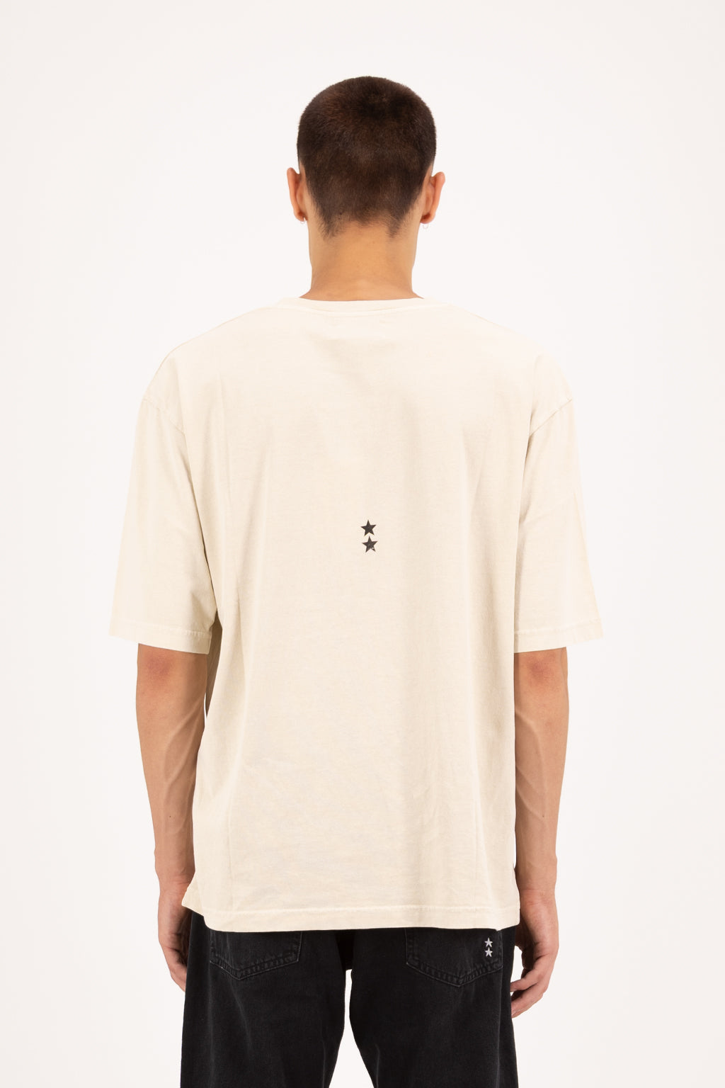 Back view of Haak men’s t-shirt in desert, 100% cotton, worn by a model with jeans.