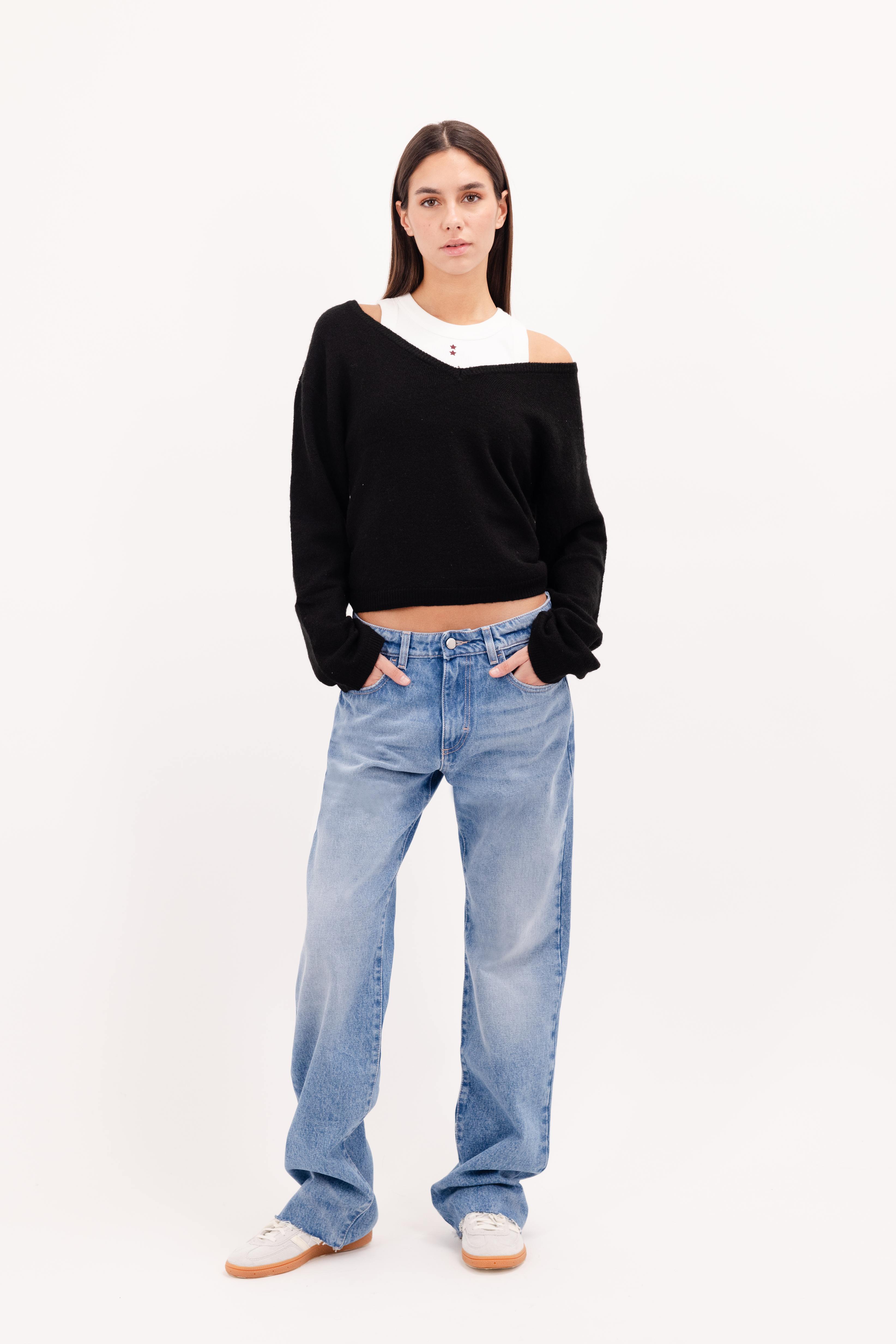 Iris Eco women’s wide leg jeans in medium wash, 100% rigid organic cotton denim, worn by a model with a black sweater.
