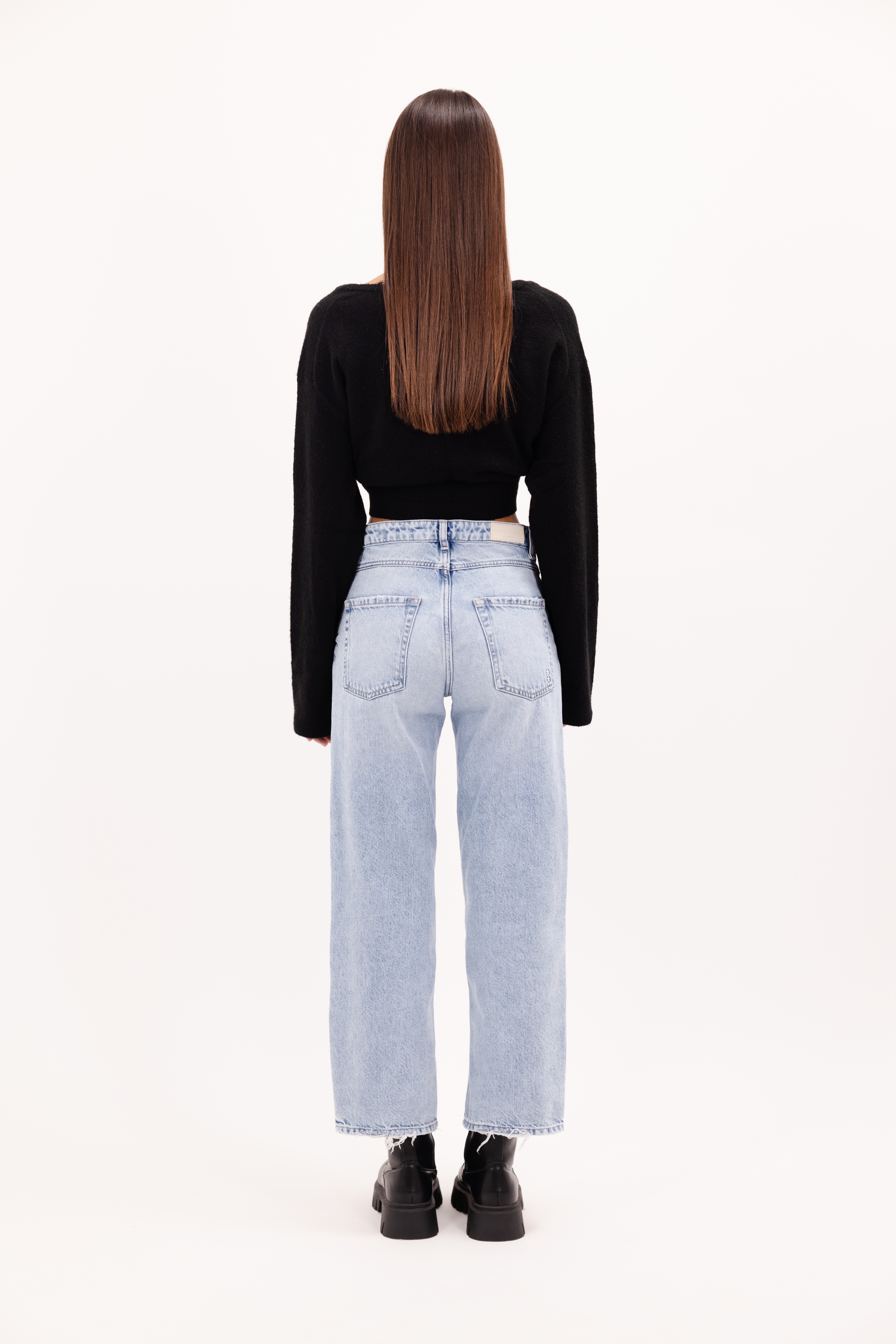 Back view of Jill women’s straight leg jeans in bleached wash, 100% rigid cotton denim, worn by a model with a black top.