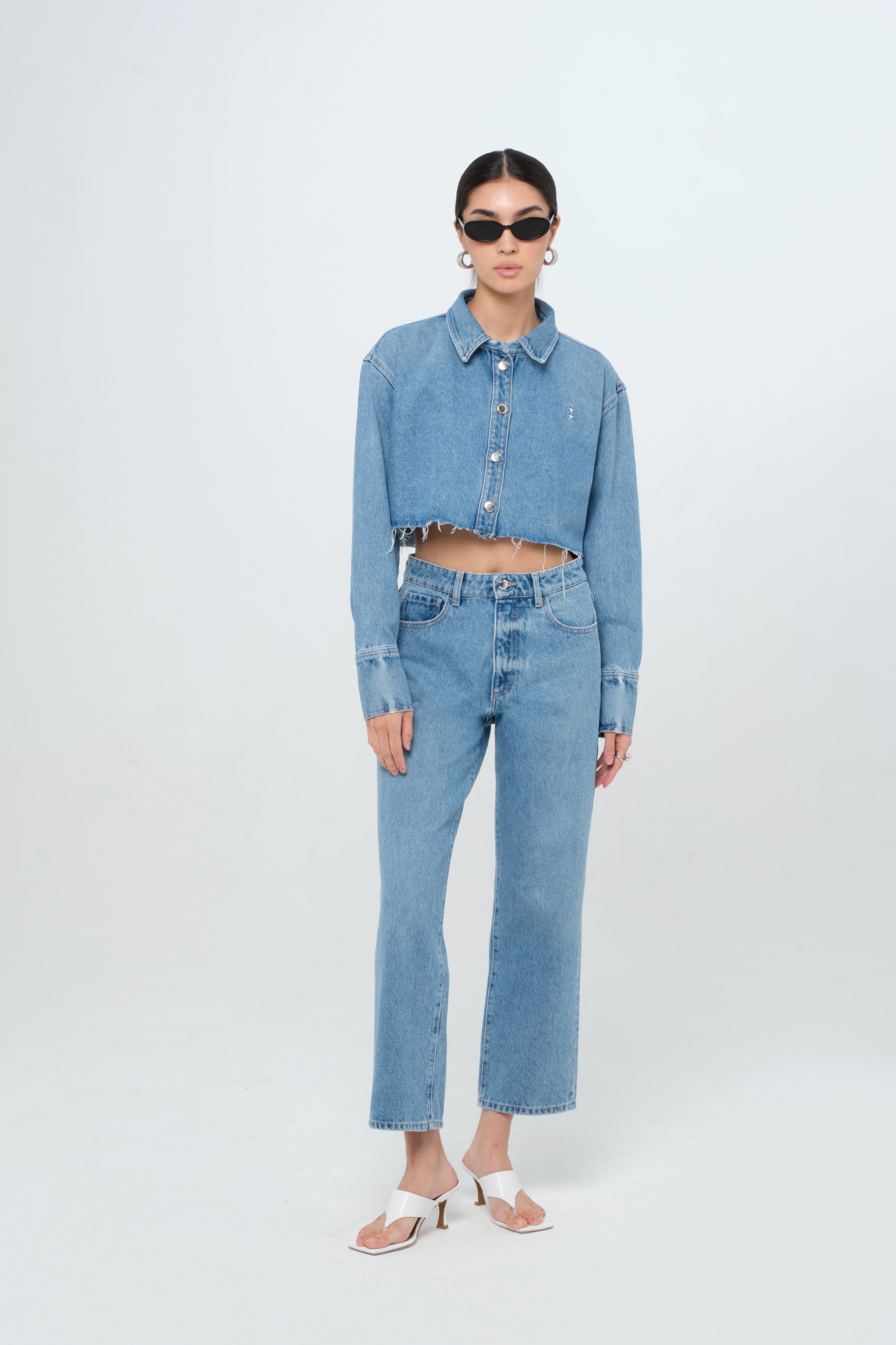 Jill women’s straight leg jeans in medium wash, 100% rigid organic cotton denim, worn by a model with a crop denim shirt.