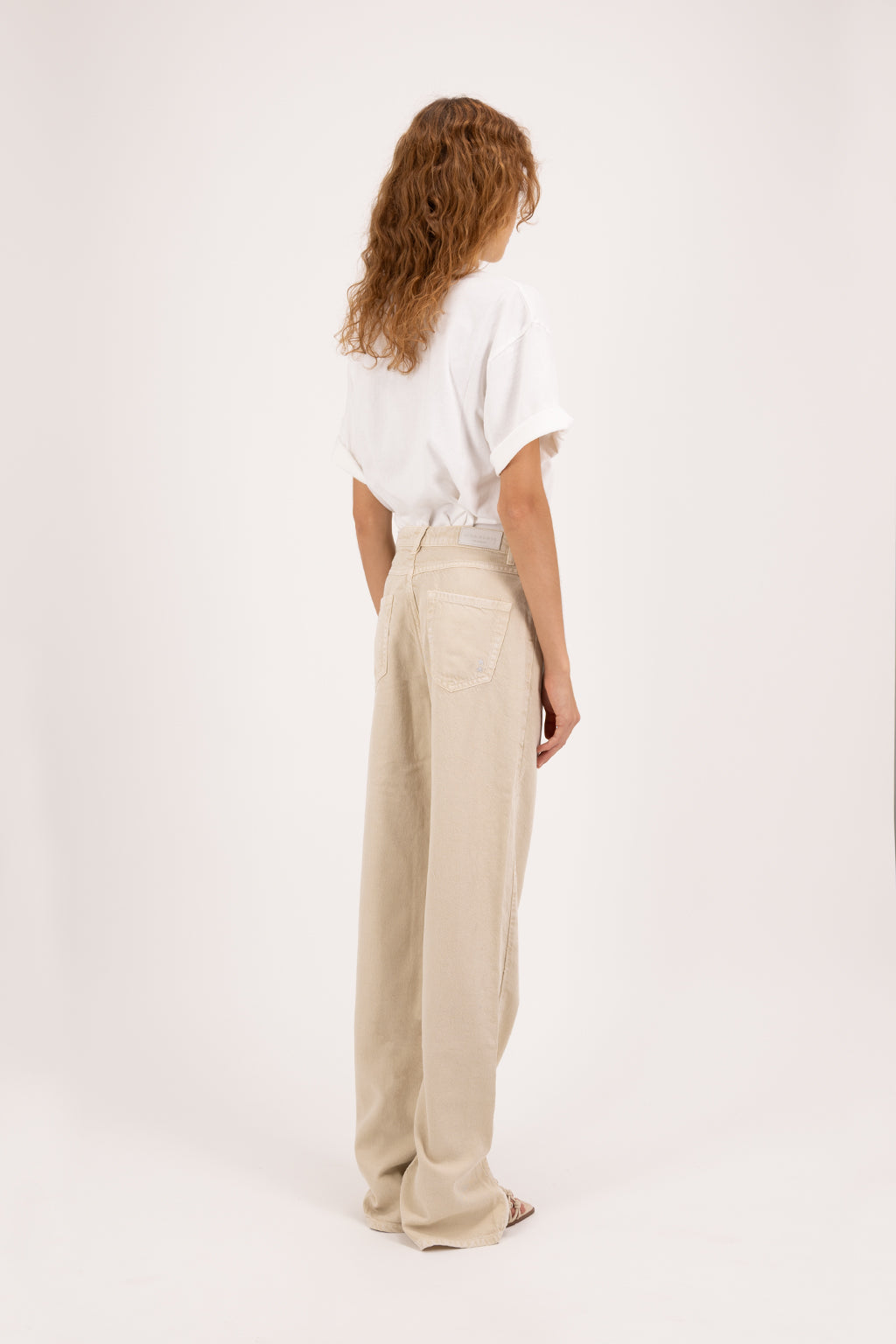 Back view of Jodie women’s straight leg jeans in desert wash, 100% rigid soft cotton denim, worn by a model with a white t-shirt.