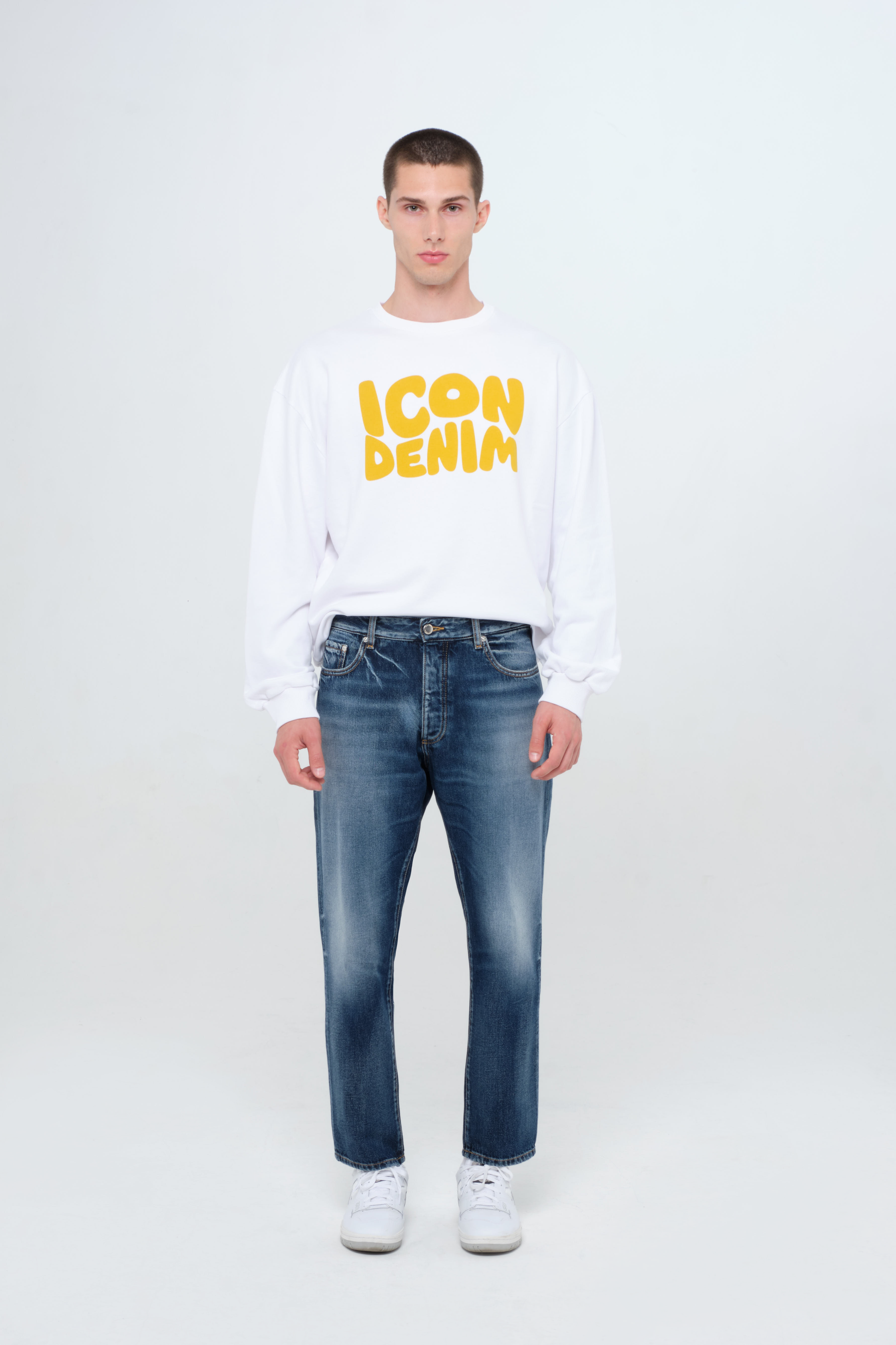 Josh men’s carrot jeans in dark wash, 100% rigid cotton denim, worn by a model with a white sweatshirt.