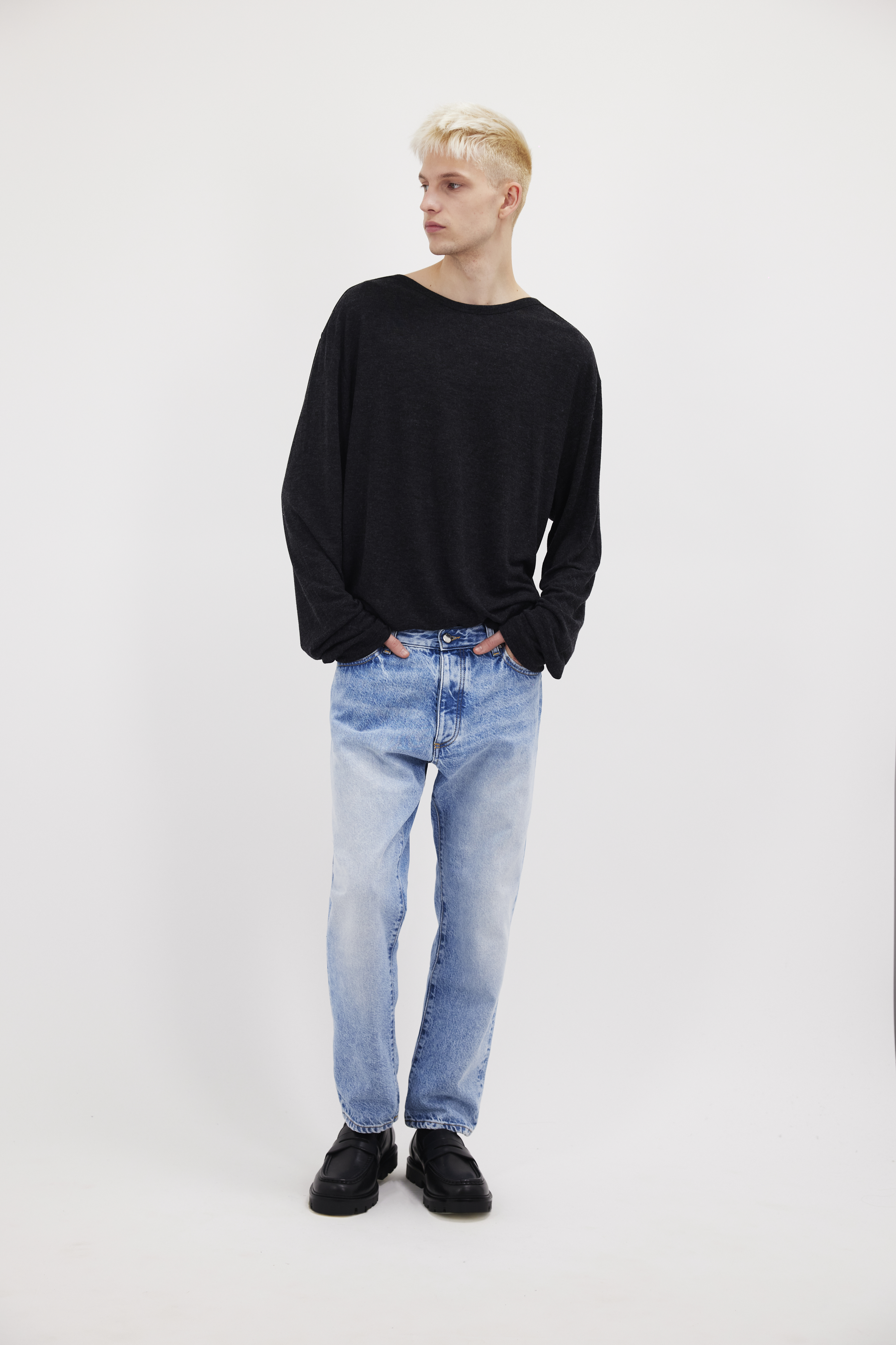 Josh men’s carrot jeans in misty blue wash, 100% rigid cotton denim, worn by a model with a black long sleeve.