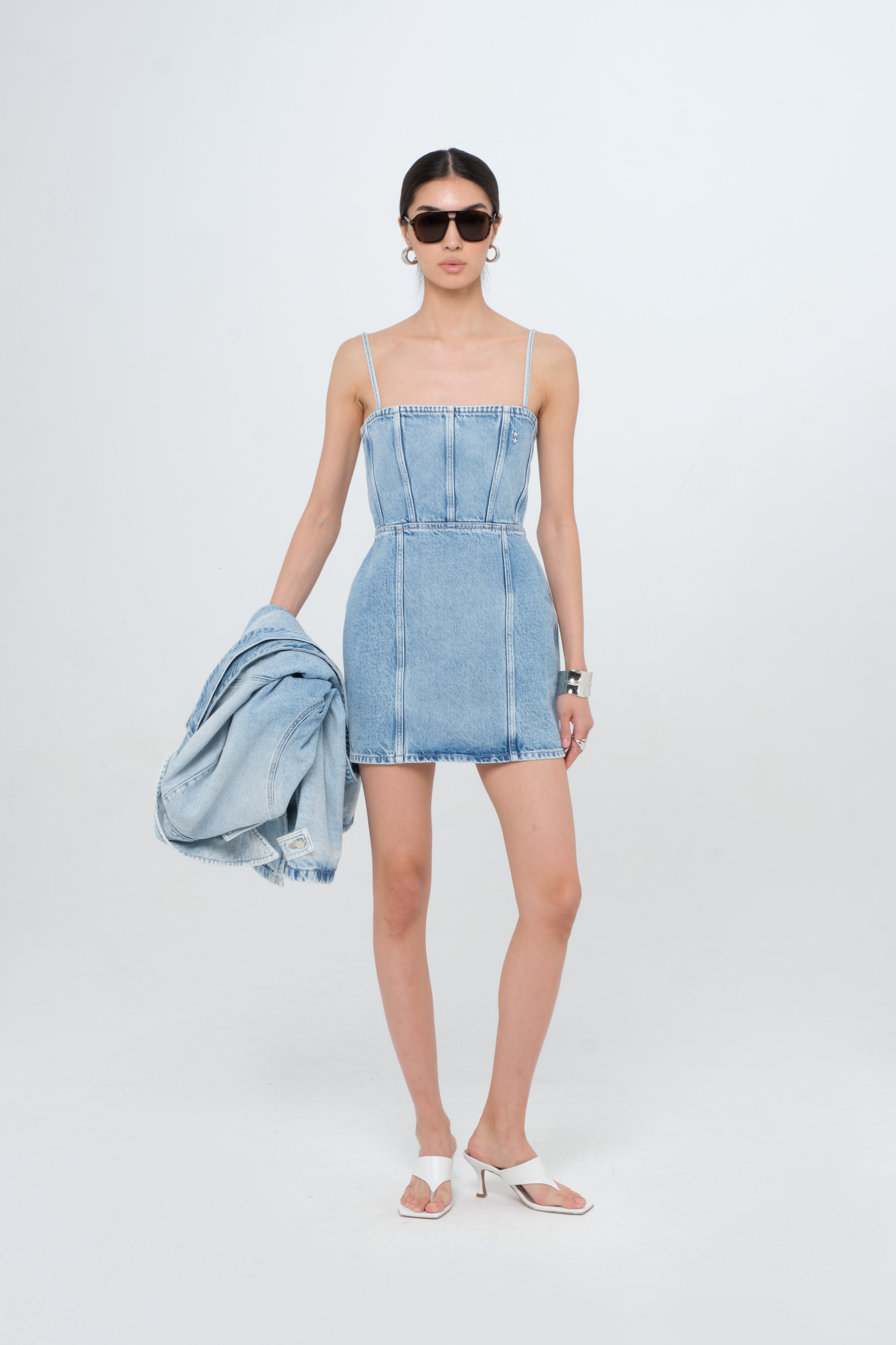 Judy women’s dress in light wash, 100% rigid cotton denim, worn by a model.
