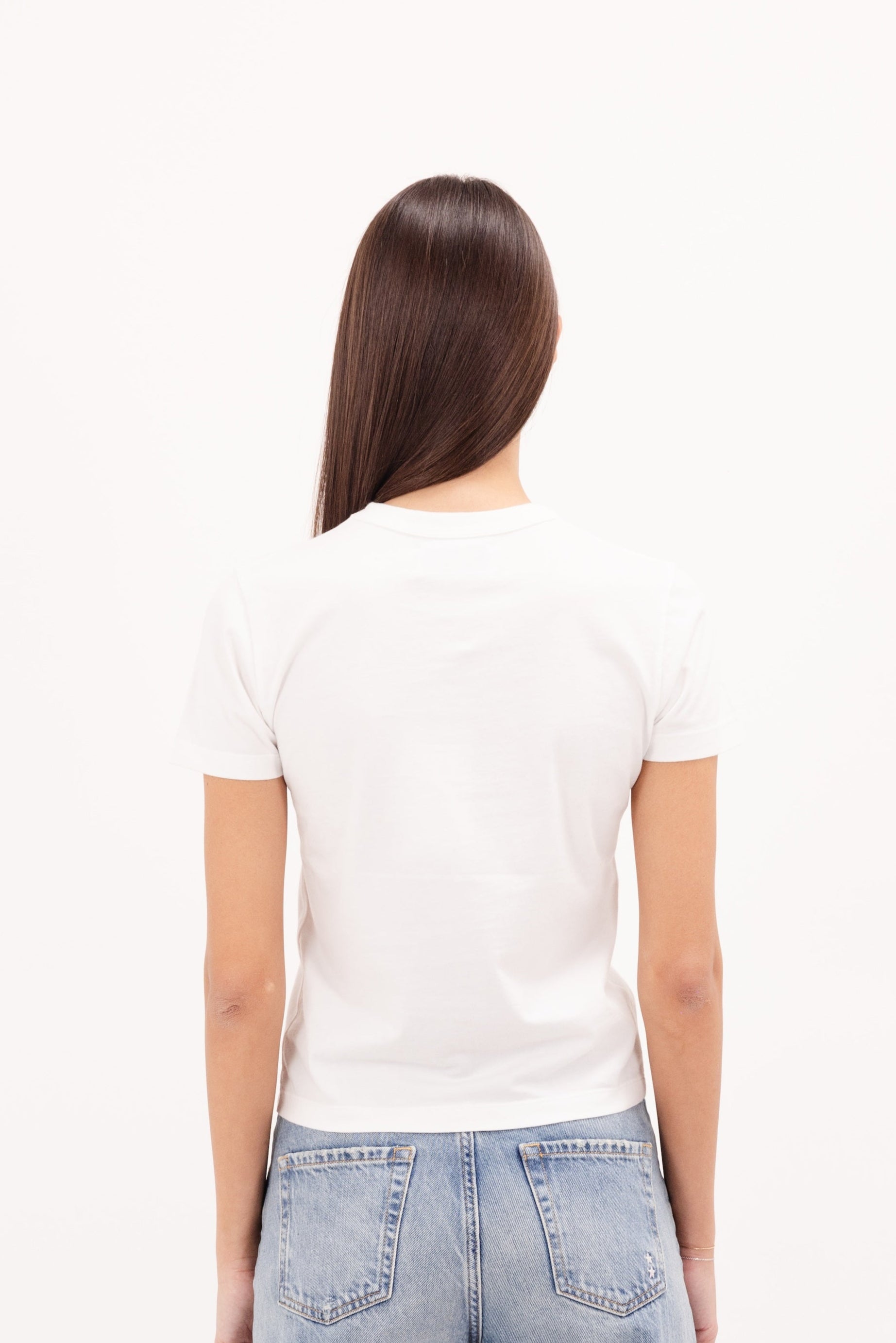 Back view of Julie women’s t-shirt in white, 100% cotton, worn by a model with jeans.
