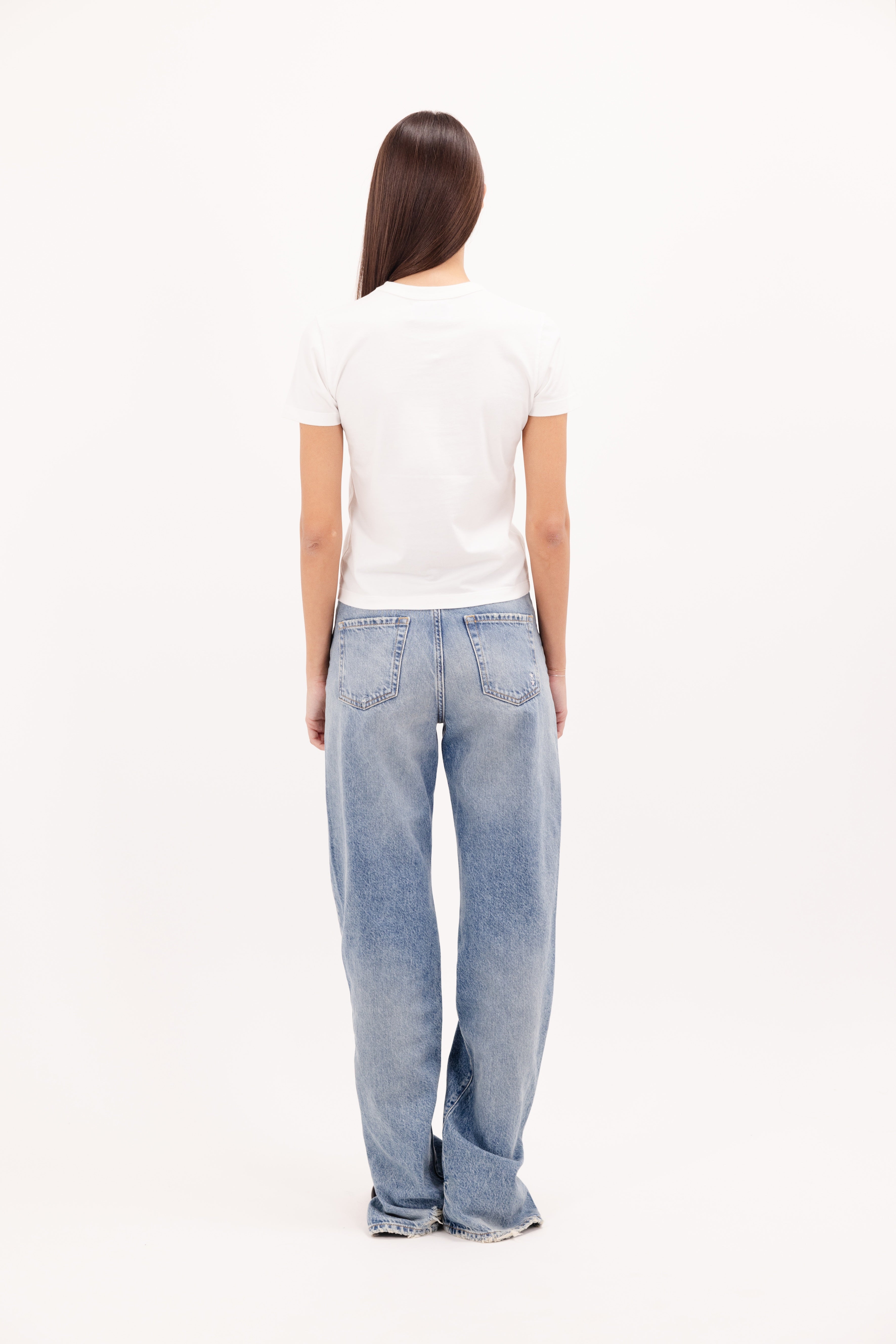 Back view of Julie women’s t-shirt in white, 100% cotton, worn by a model with jeans.
