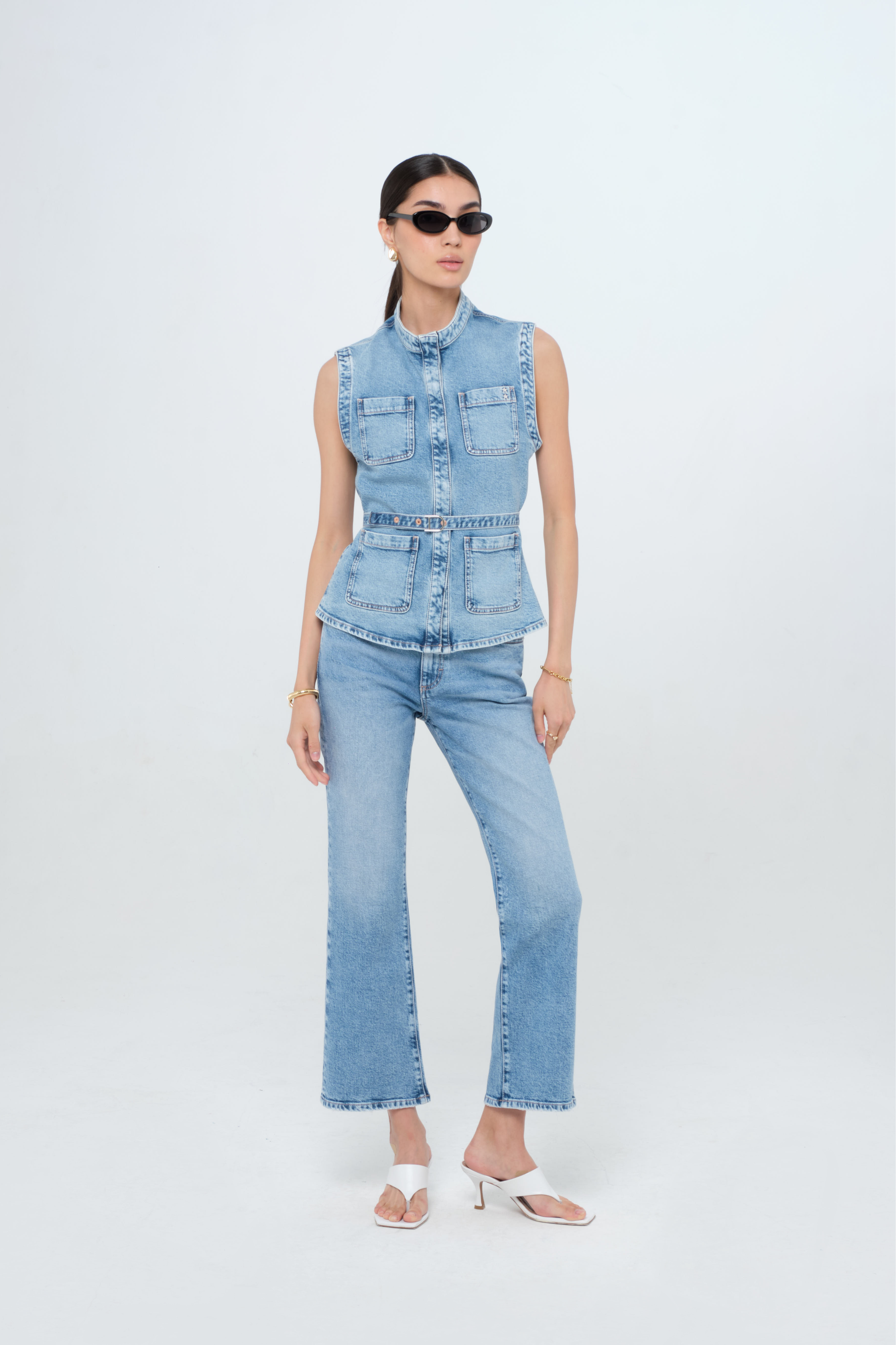 Kelly women’s vest in medium wash, 100% rigid cotton denim, worn by a model with jeans.