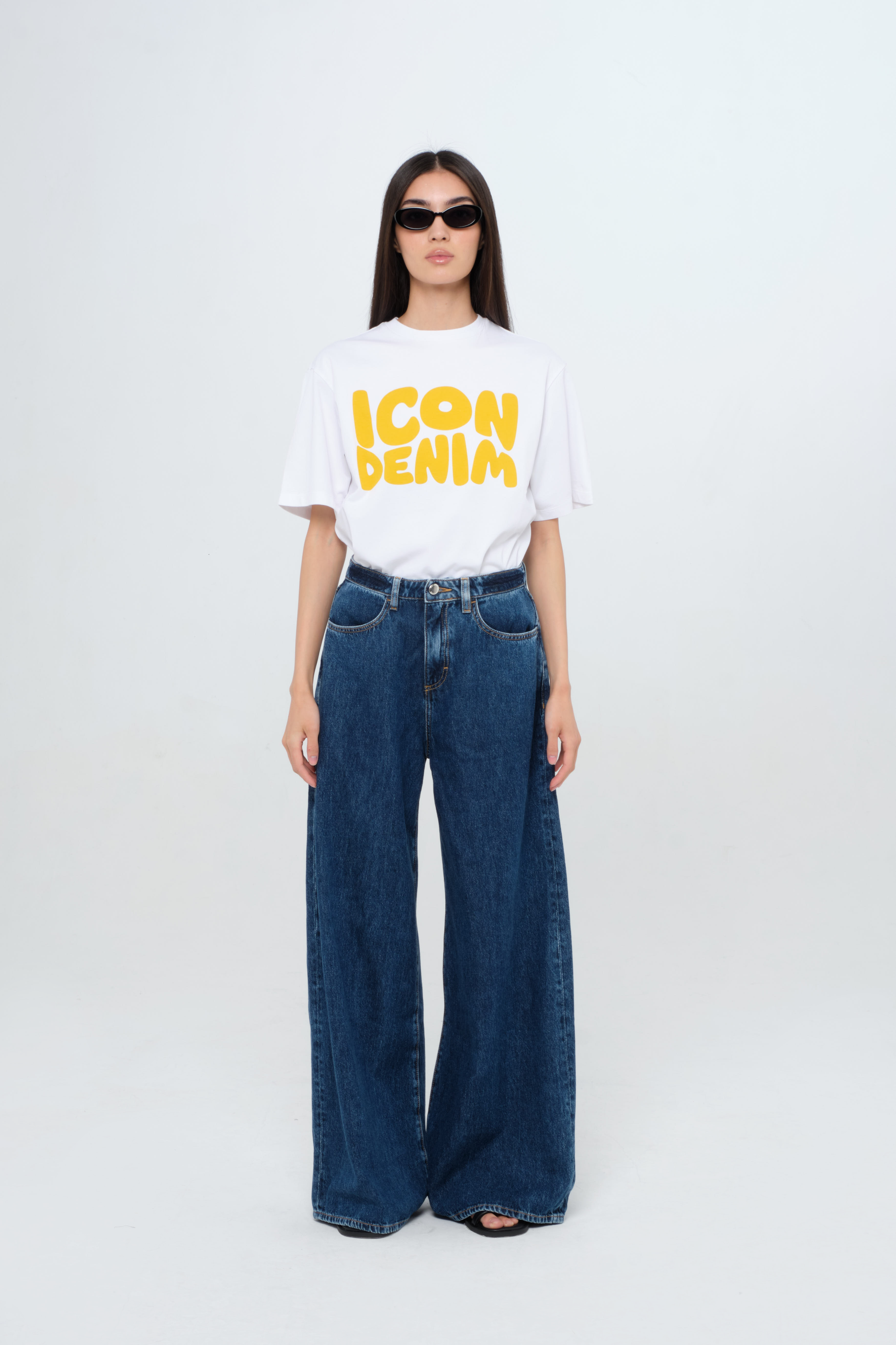 Kendall women’s wide leg jeans in dark wash, 100% rigid cotton denim, worn by a model with a white t-shirt.