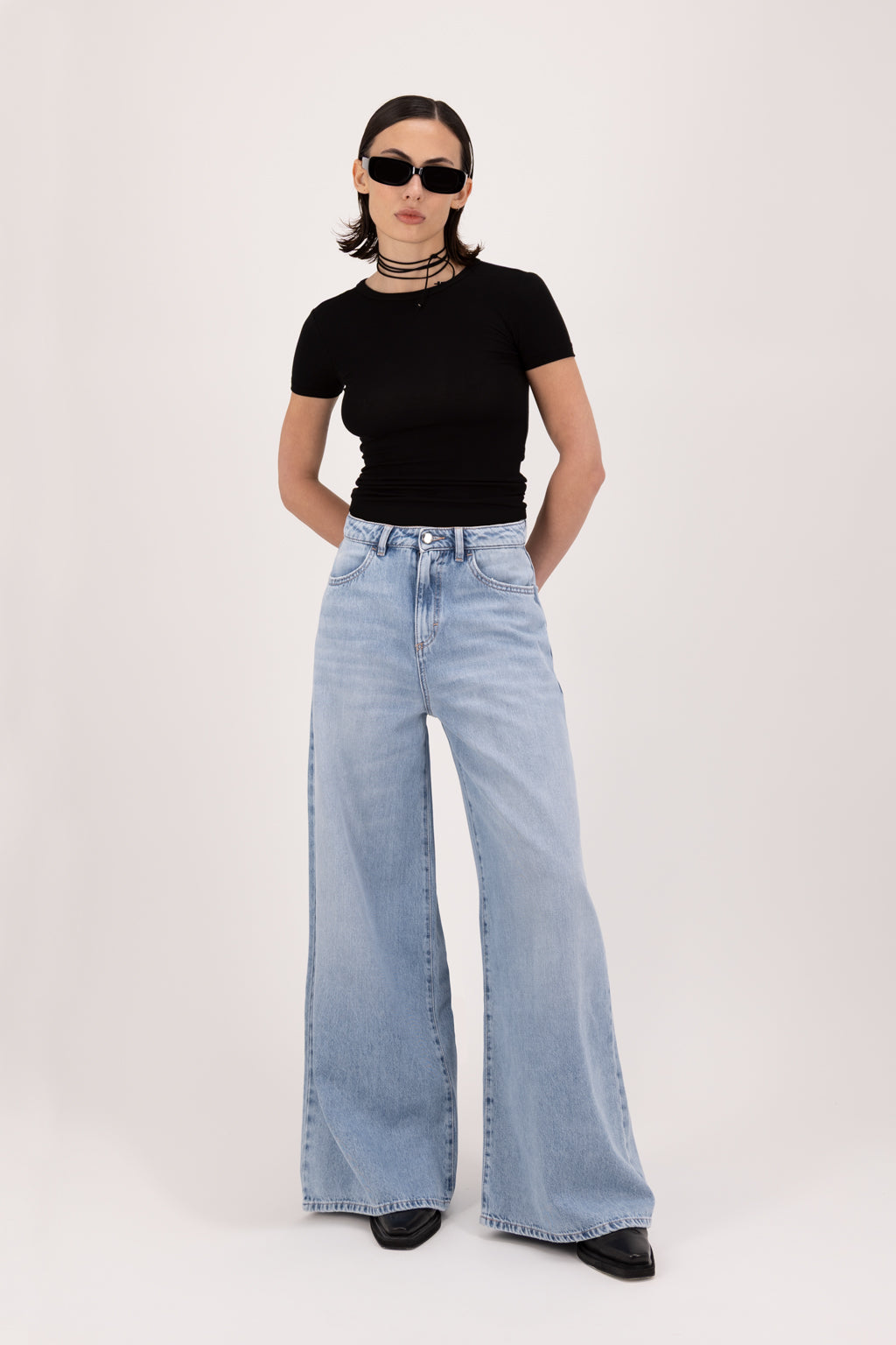 Kendall women’s wide leg jeans in sky blue wash, 100% rigid cotton denim, worn by a model with a black top.
