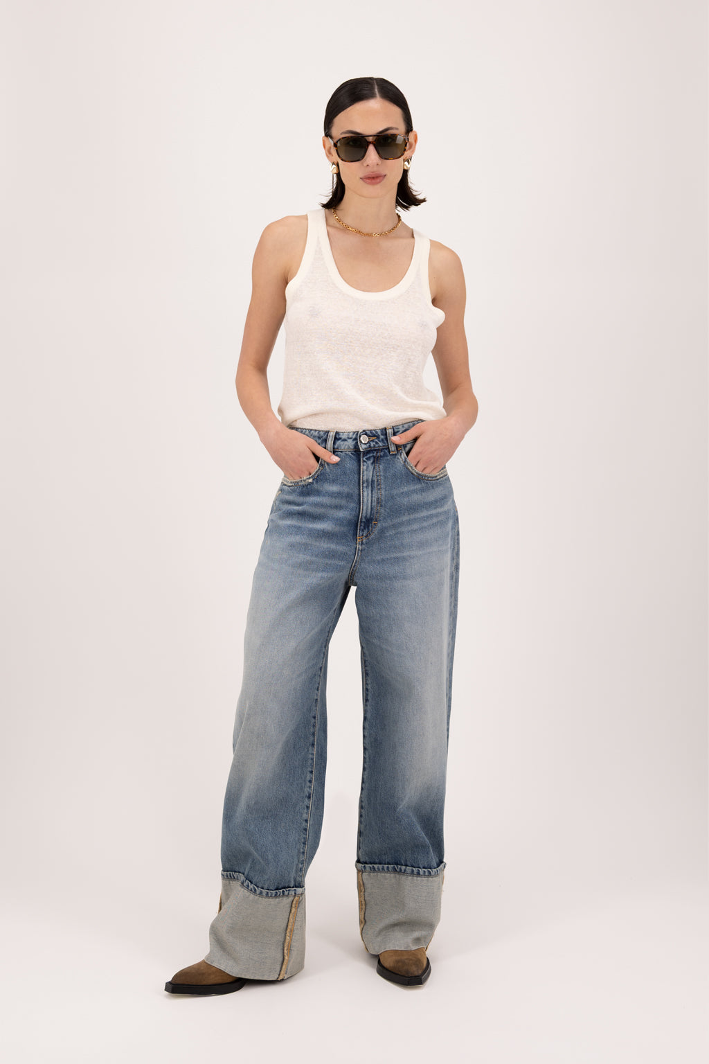 Kiki women’s wide leg jeans in smoke blue wash, 100% rigid cotton denim, worn by a model with a white tank top.
