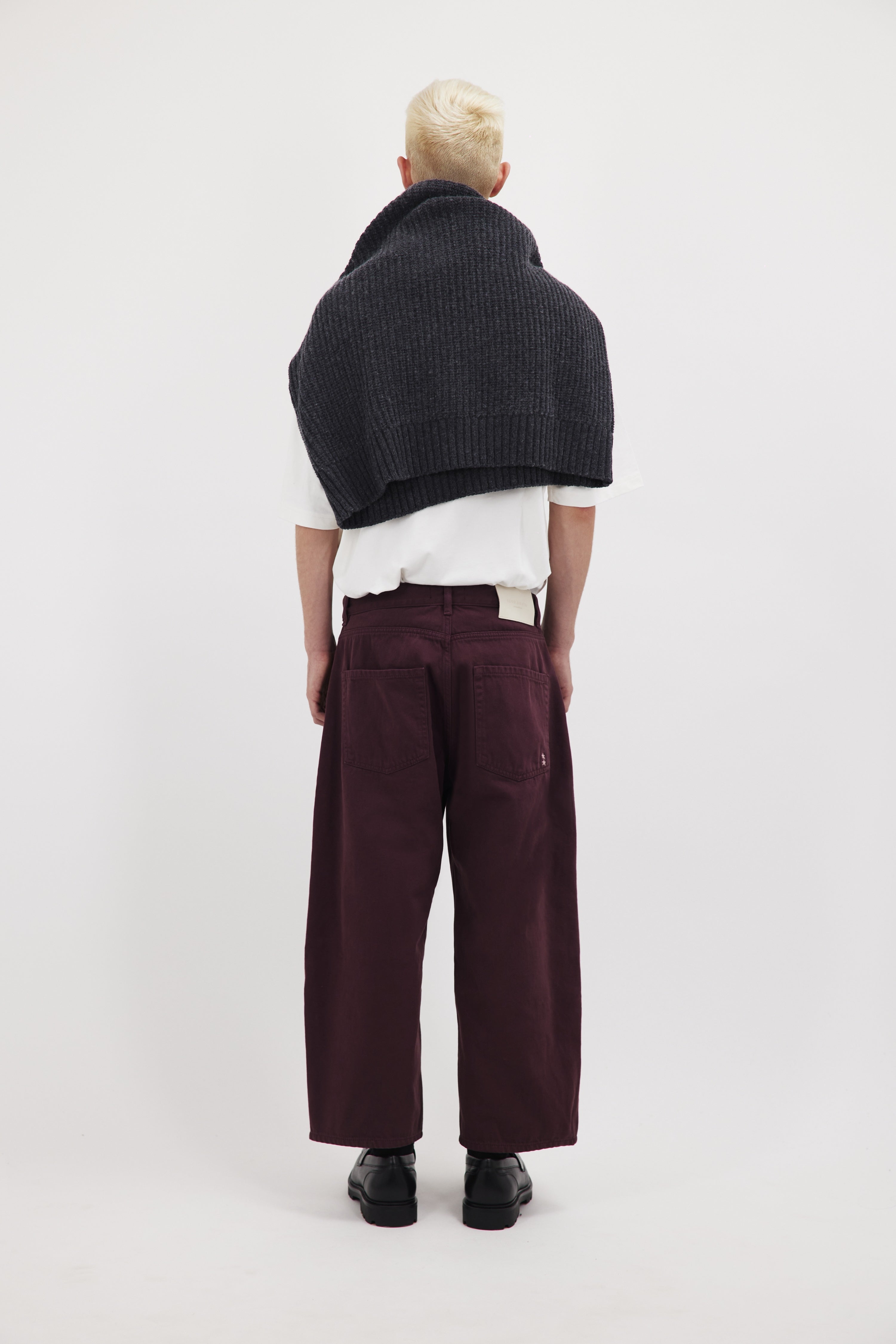 Back view of Leo men’s wide leg crop jeans in cherry wash, 100% rigid cotton denim, worn by a model with a white t-shirt.