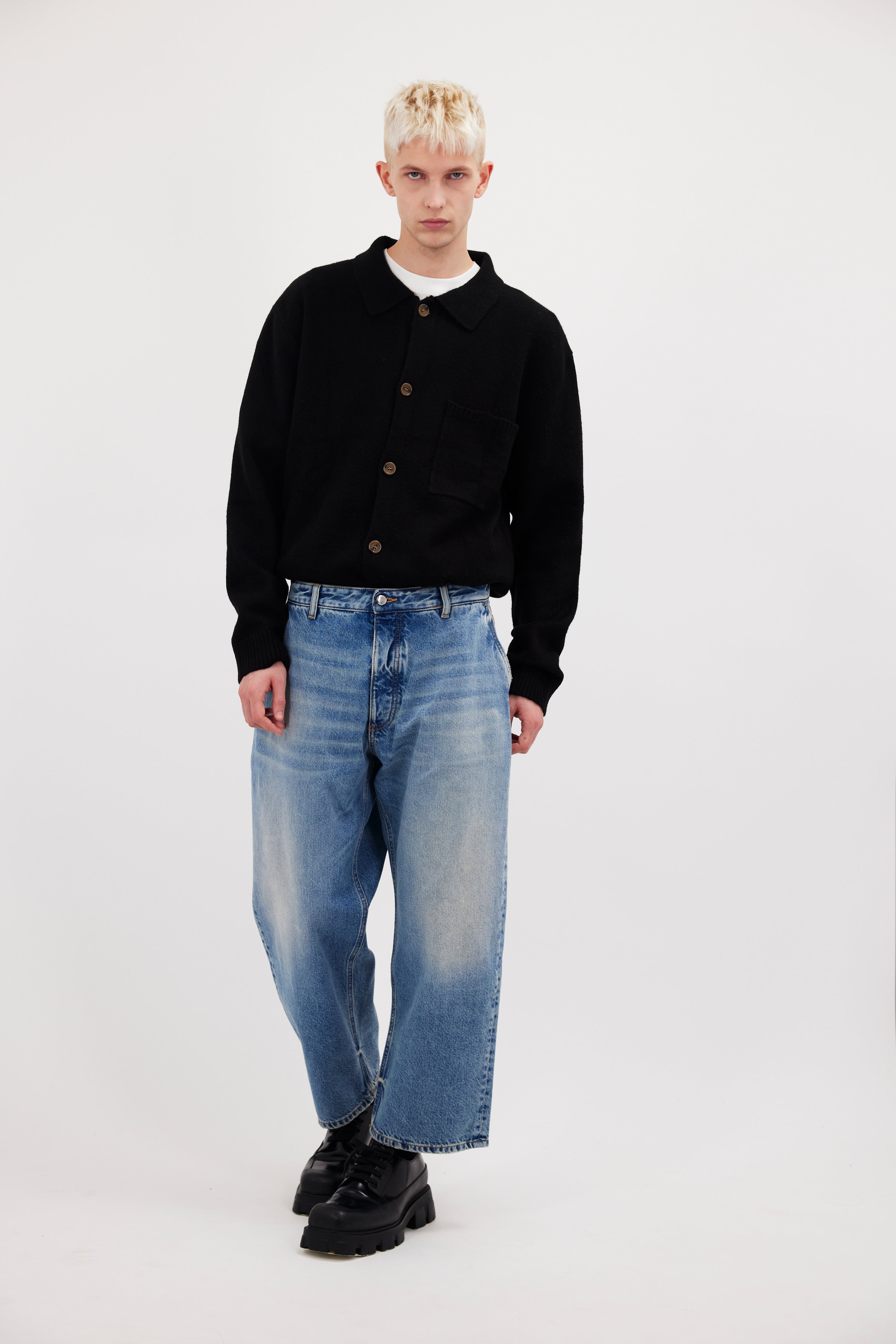 Leo men’s wide leg crop jeans in smoke blue wash, 100% rigid cotton denim, worn by a model with a black cardigan.