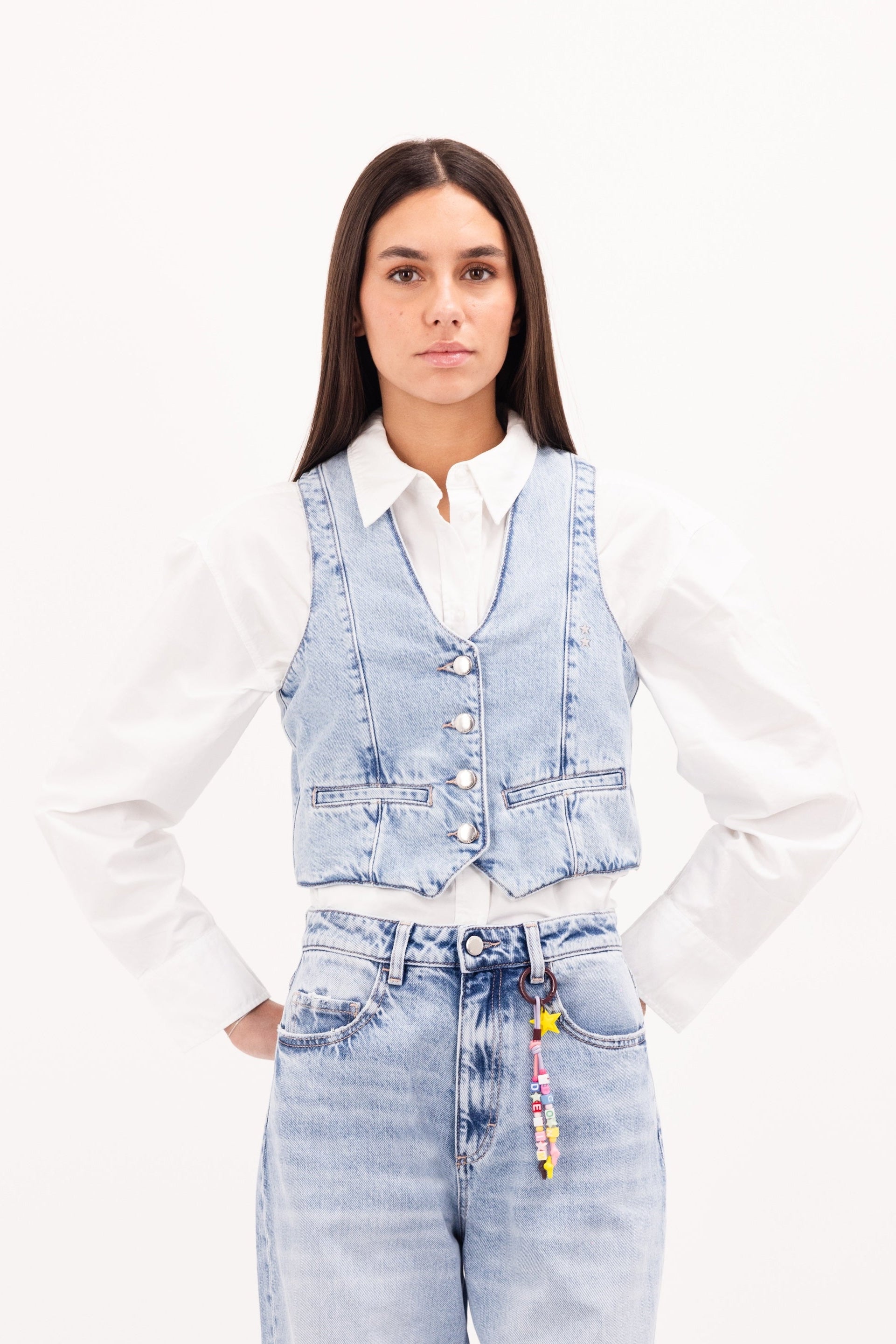 Liv women’s vest in sky blue wash, 100% rigid cotton denim, worn by a model with jeans.