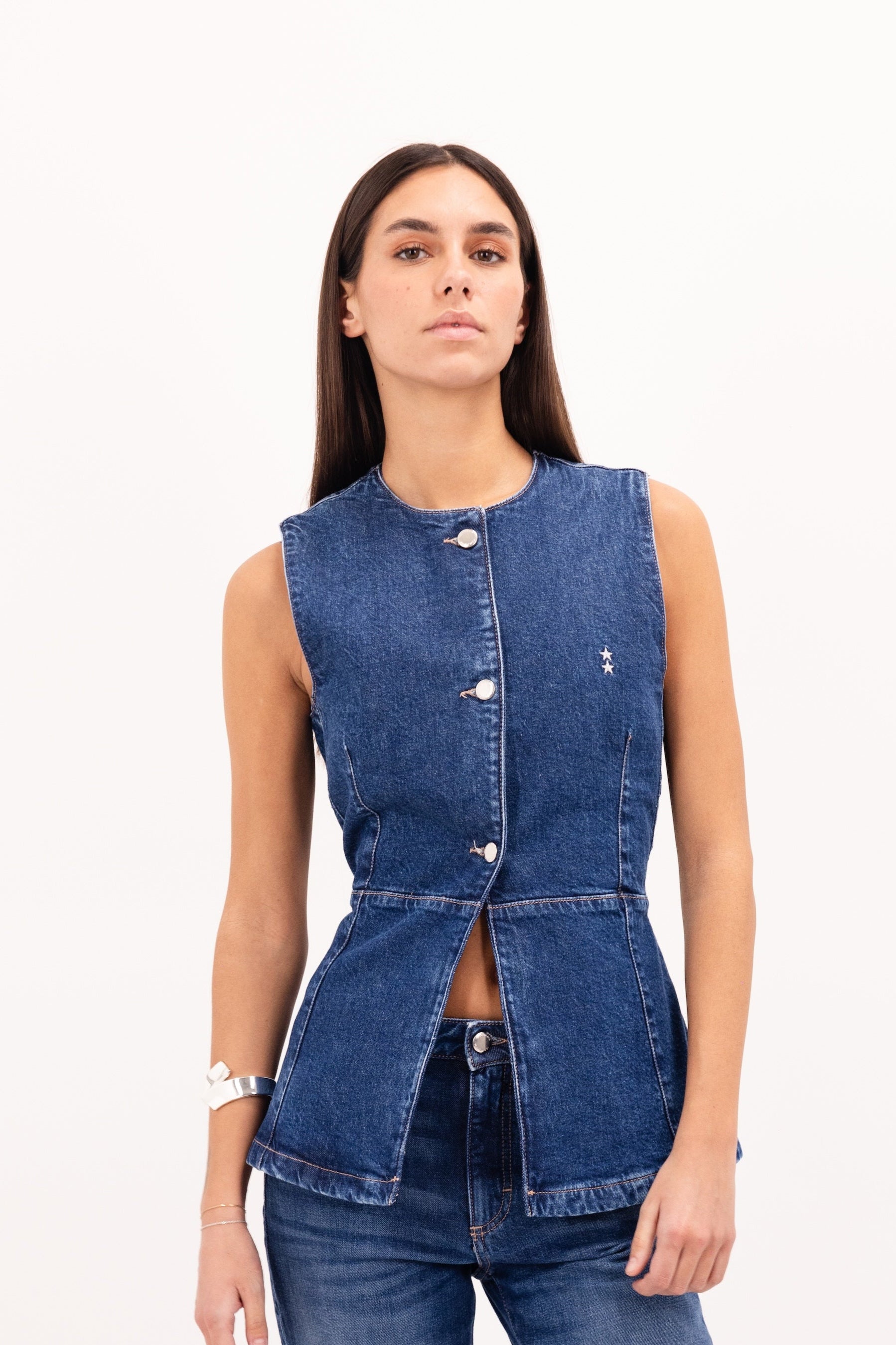 Lola women’s vest in eclipse wash, 100% rigid cotton denim, worn by a model with jeans.