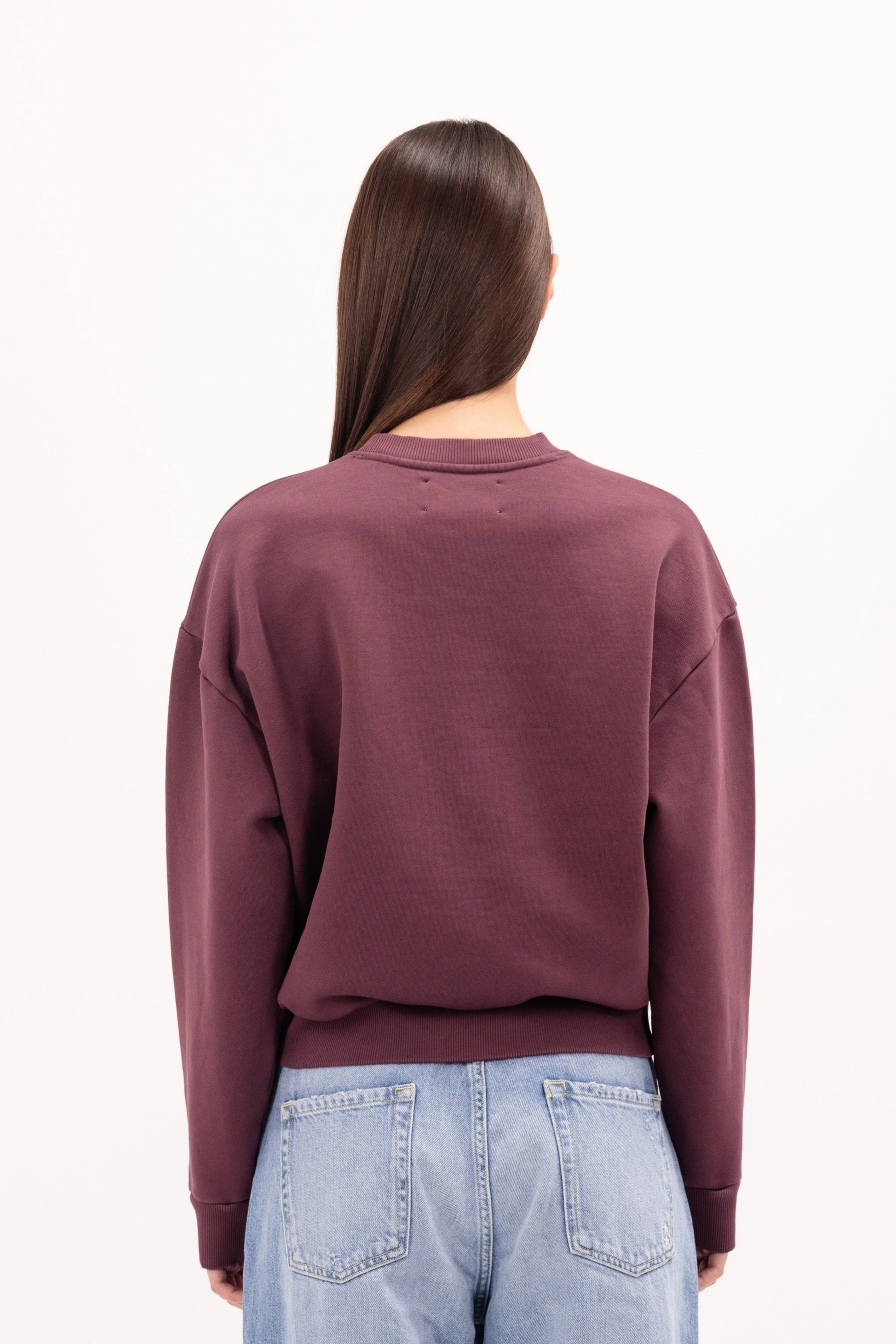 Back view of Mellie women’s sweatshirt in cherry, 100% cotton, worn by a model.
