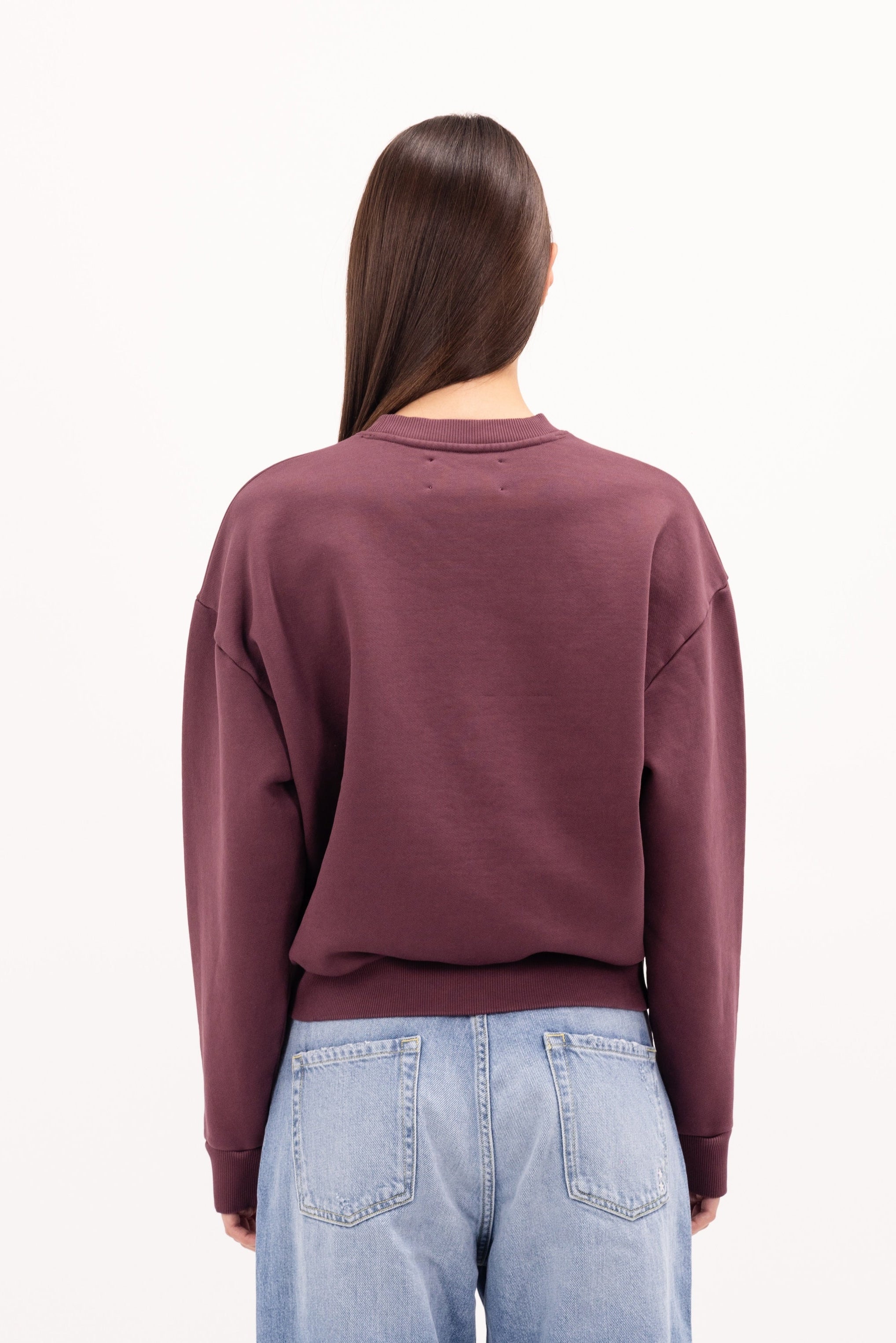 Back view of Mellie women’s sweatshirt in cherry, 100% cotton, worn by a model.
