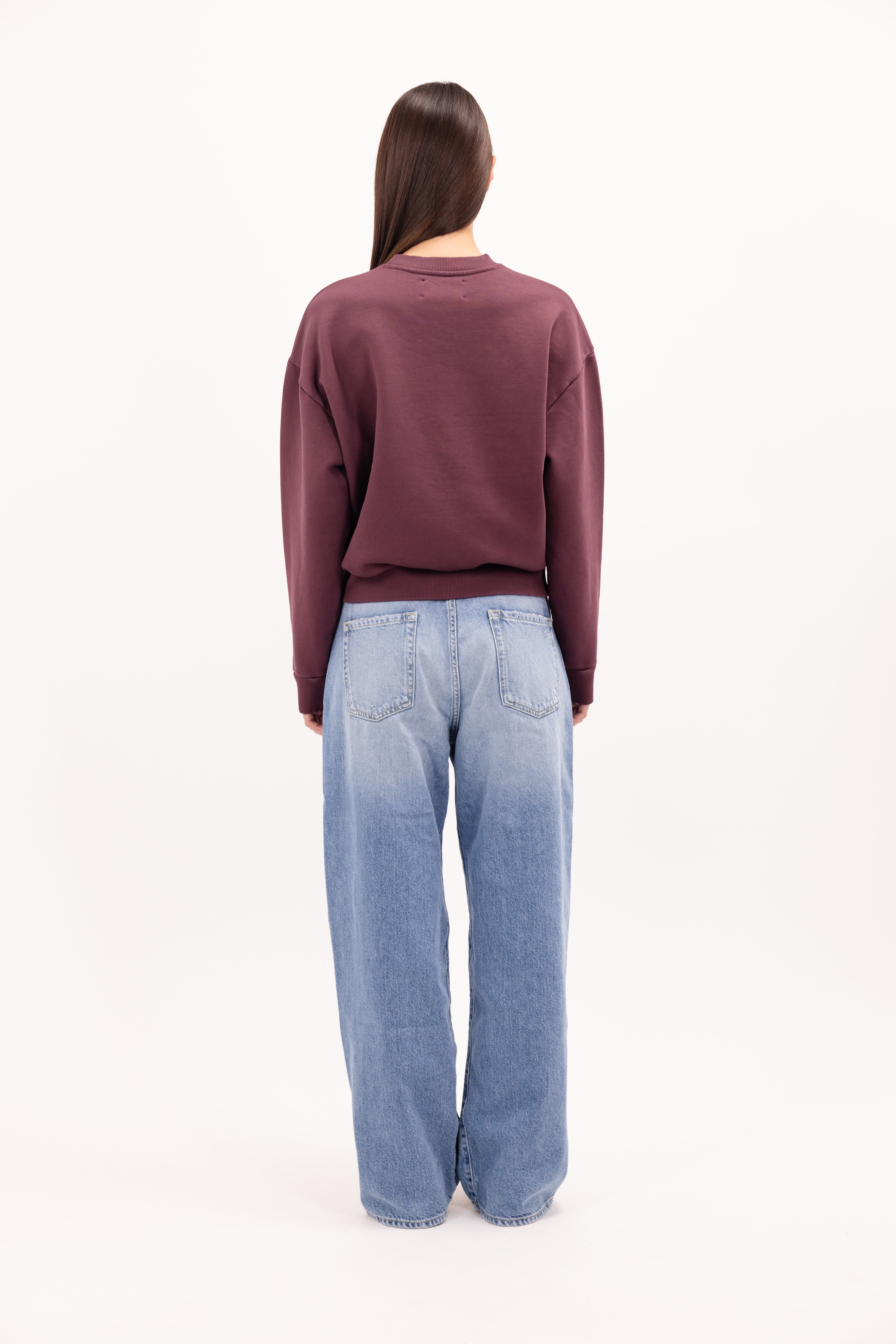 Back view of Mellie women’s sweatshirt in cherry, 100% cotton, worn by a model.