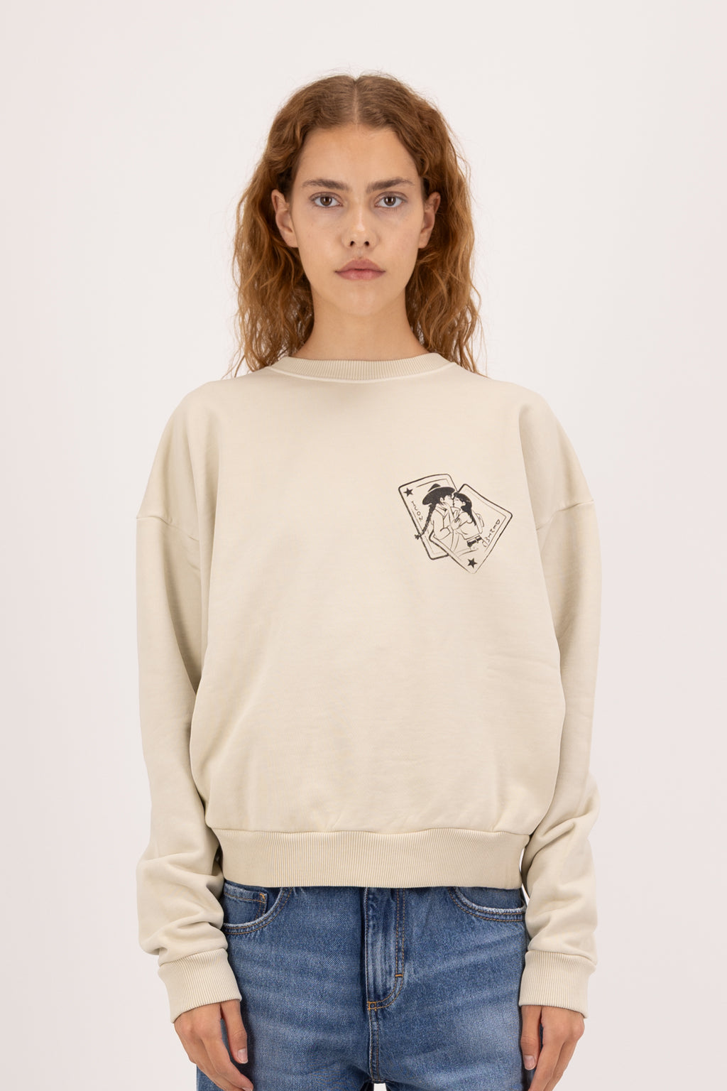 Mellie women’s sweatshirt in desert, 100% cotton, worn by a model with jeans.