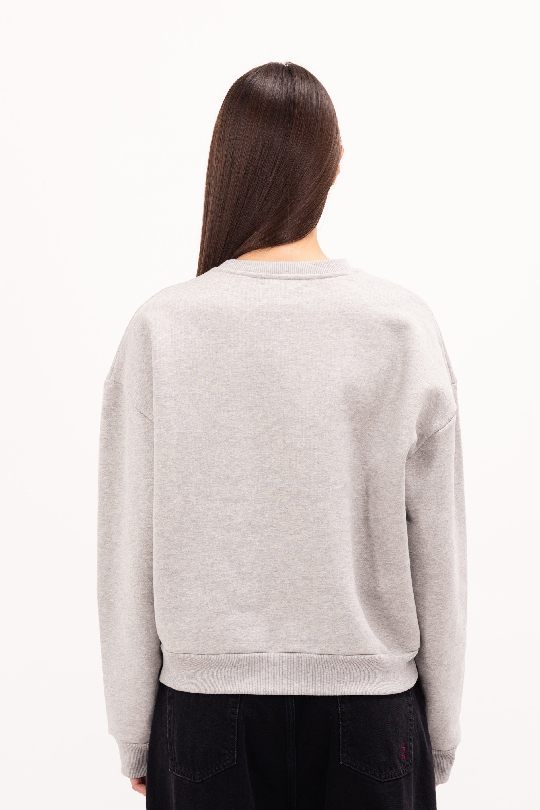 Back view of Mellie women’s sweatshirt in gray, 100% cotton, worn by a model.