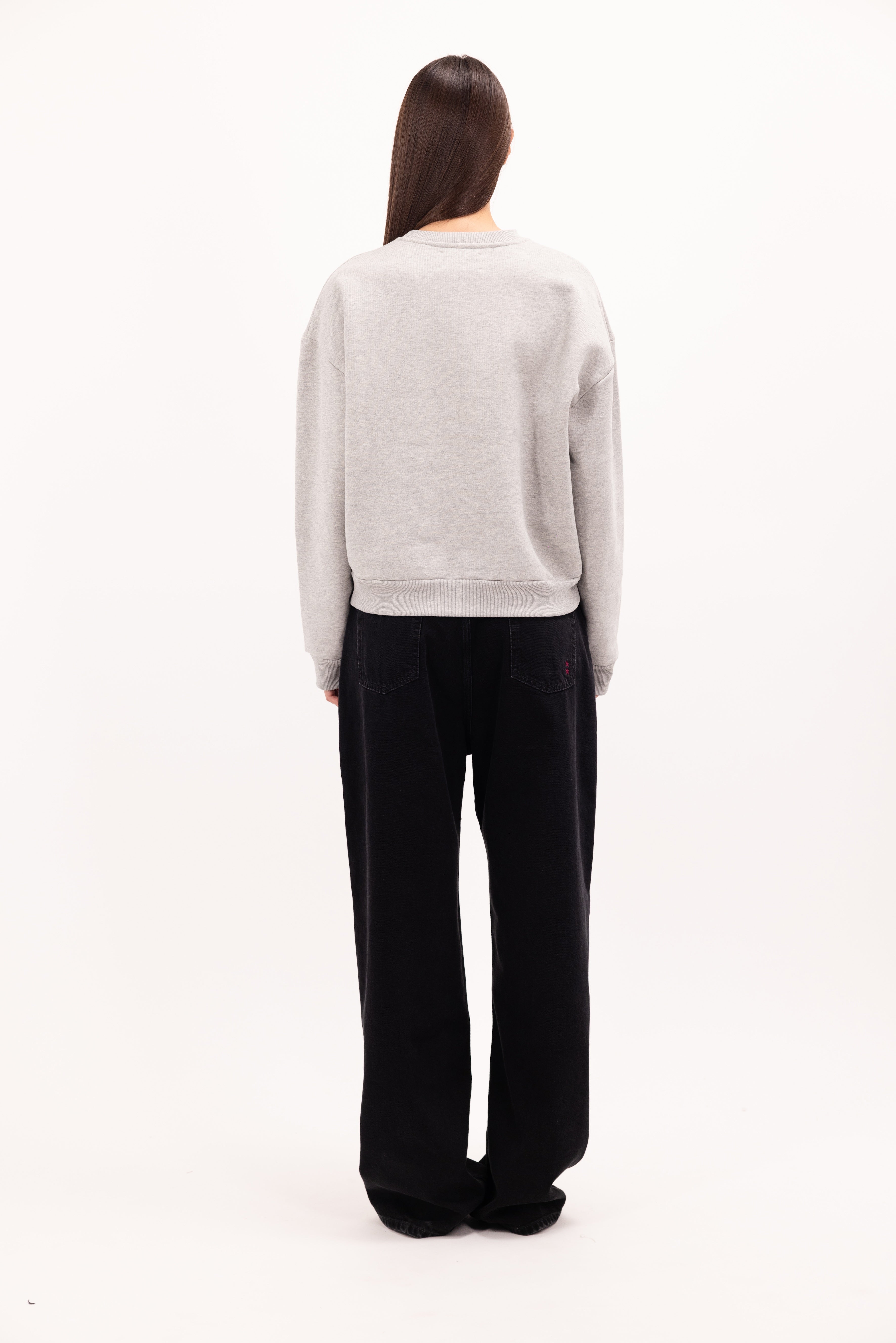 Back view of Mellie women’s sweatshirt in gray, 100% cotton, worn by a model.