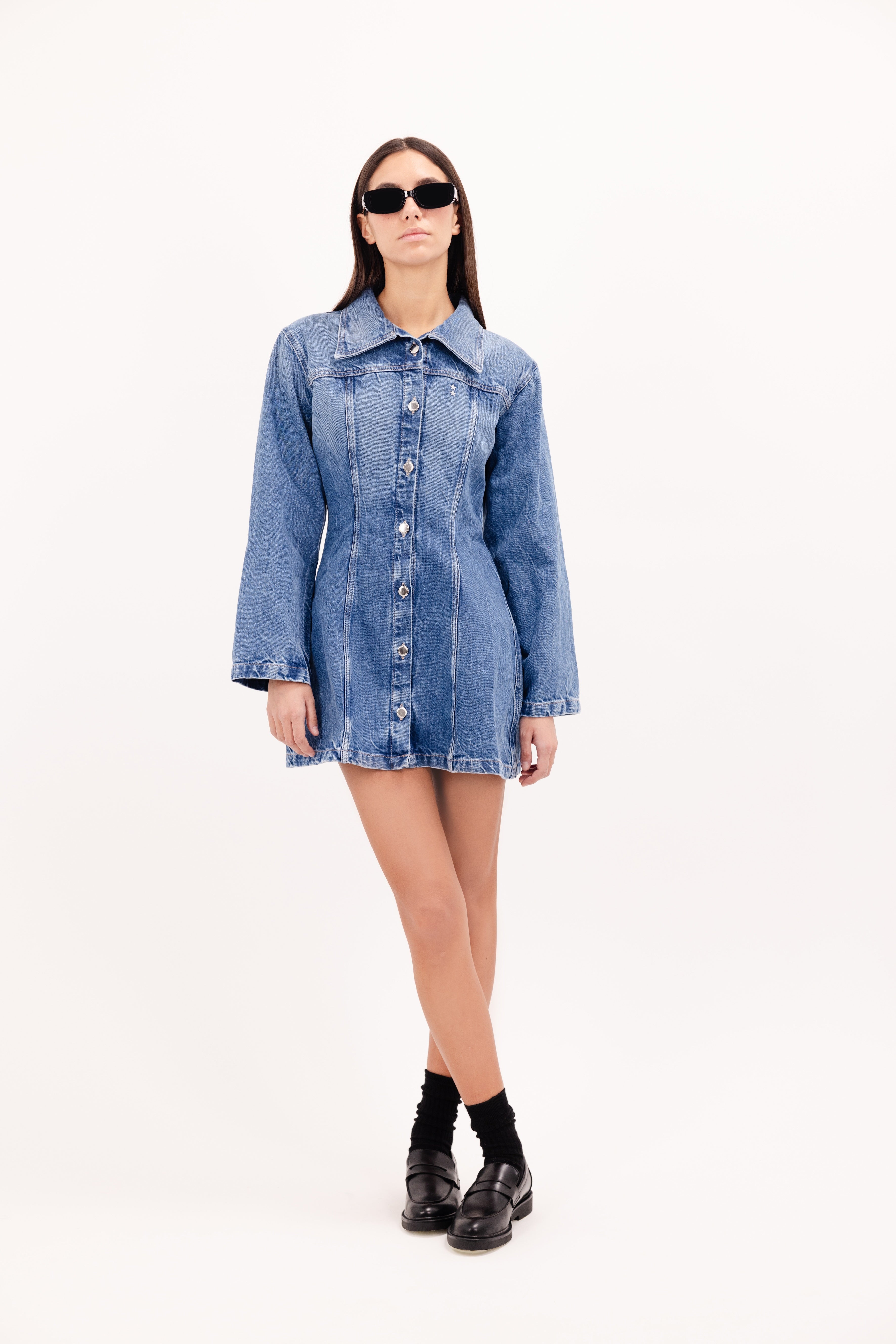 Mya women’s dress in eclipse wash, 100% rigid cotton denim, worn by a model.
