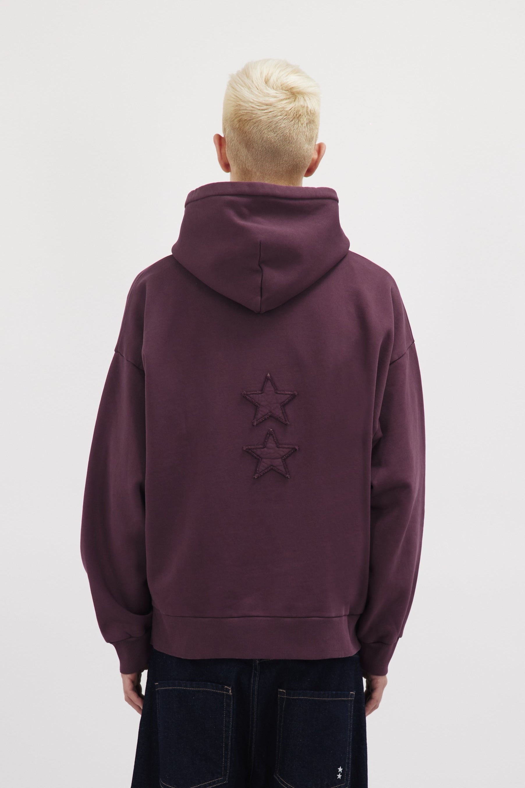 Back view of Owen men’s hoodie in cherry, 100% cotton, worn by a model.